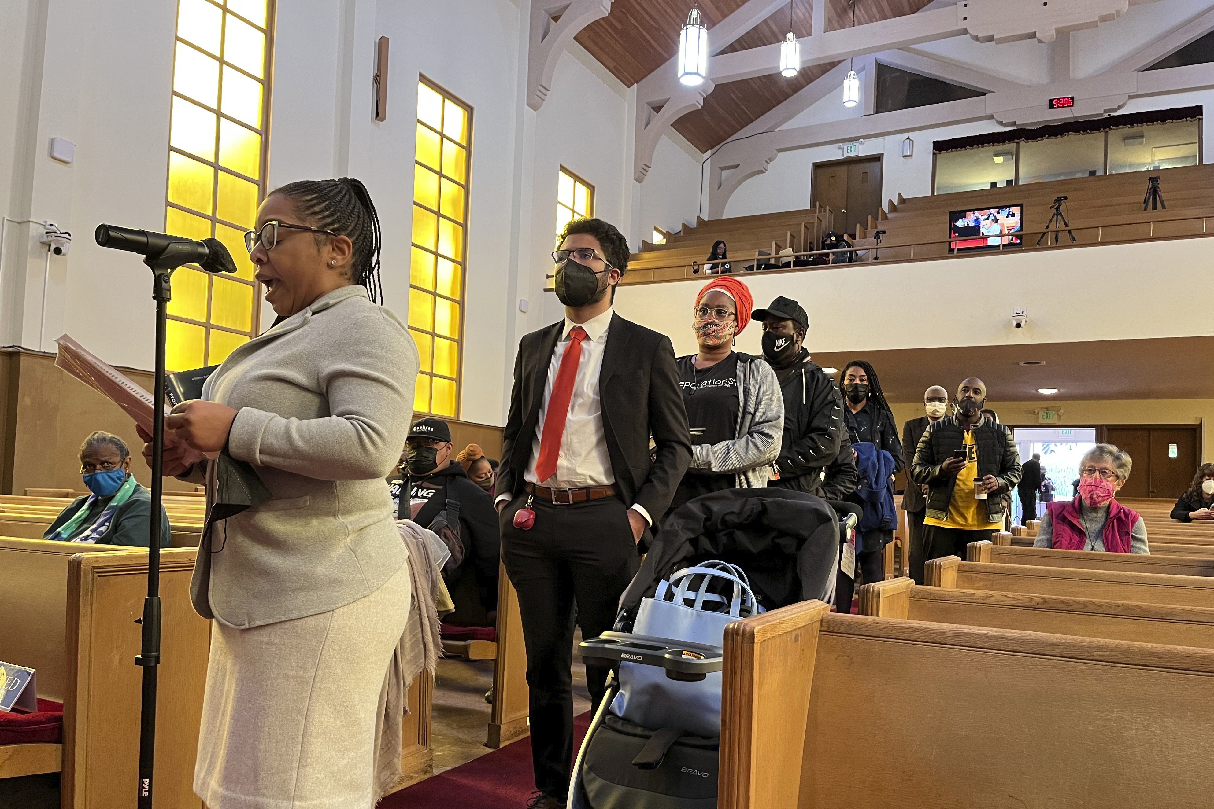 People line up to speak during a reparations task force meeting at Third Baptist Church in San Francisco on April 13. A report by California's first in the nation task force on reparations Wednesday will document in detail the harms perpetuated by the state against Black people and recommend ways to address those wrongs.