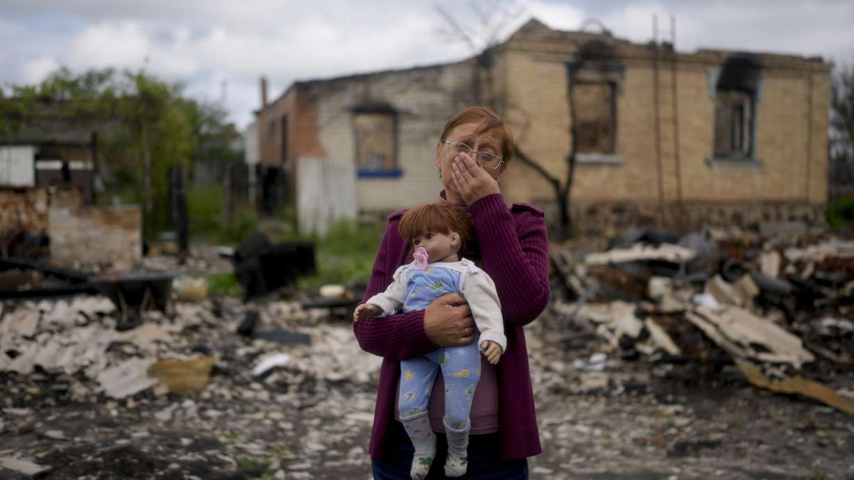 Nila Zelinska holds a doll belonging to her granddaughter, she was able to find in her destroyed house in Potashnya outskirts Kyiv, Ukraine, Tuesday. Zelinska just returned to her home town after escaping war to find out she is homeless.