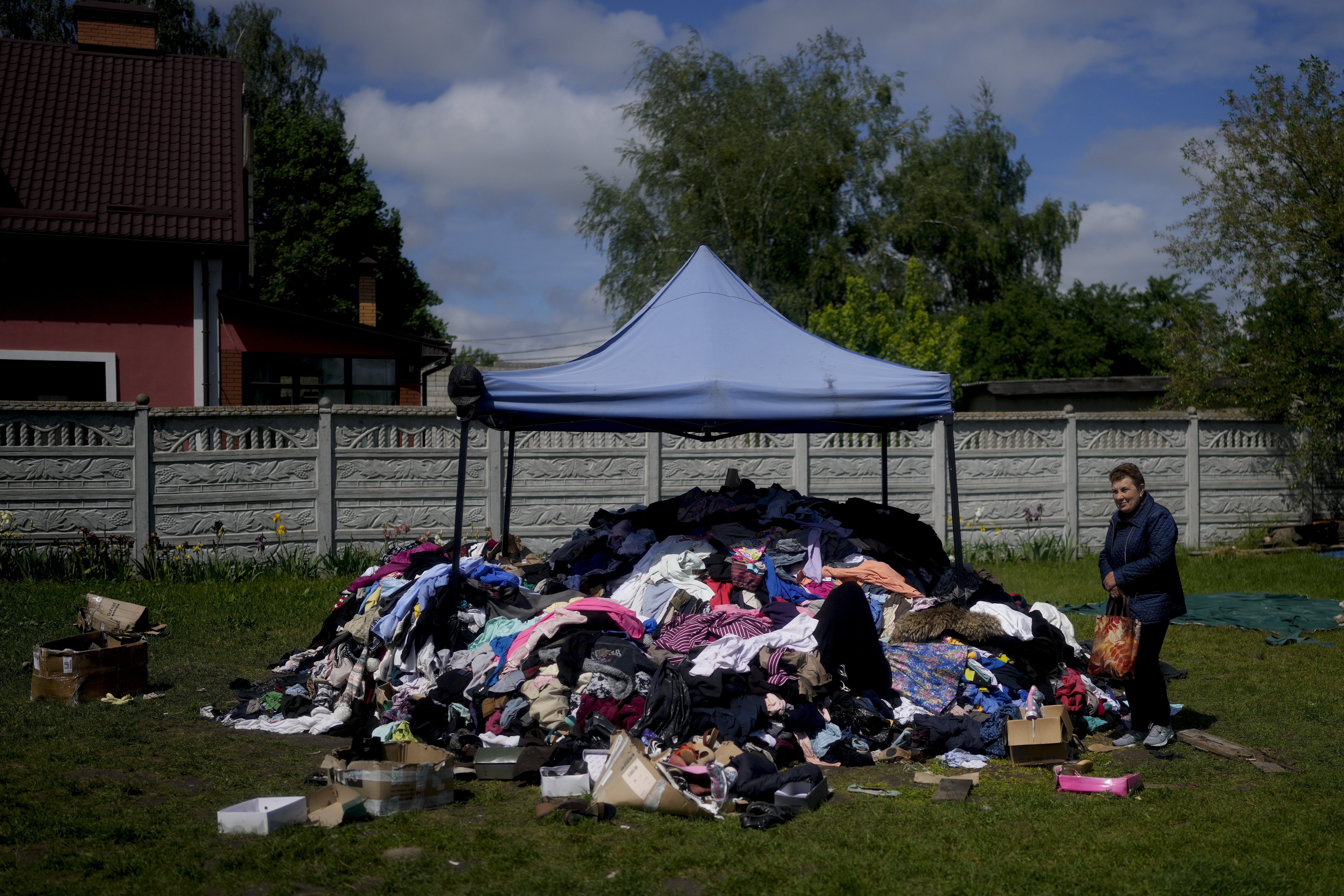 A woman stands outside a church to receive clothing in Borodyanka, on the outskirts of Kyiv, Ukraine, Tuesday.
