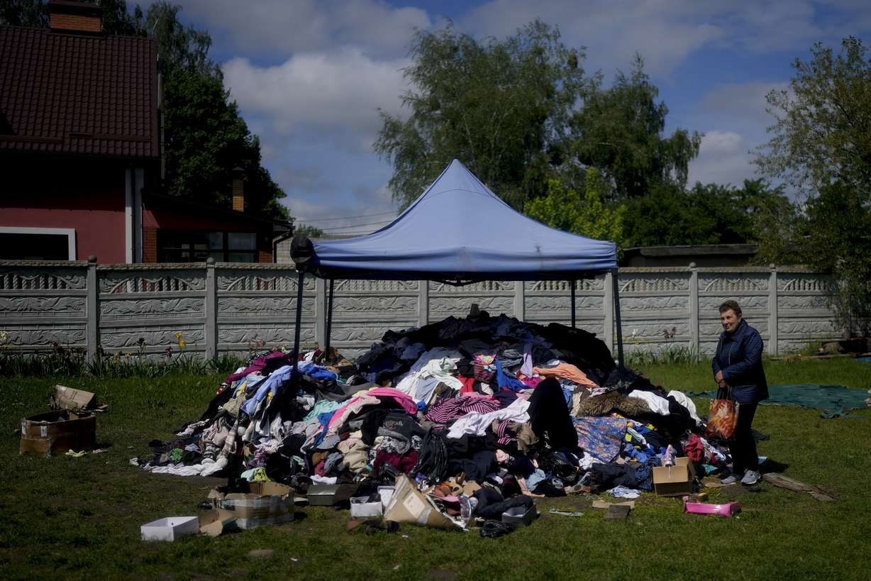 A woman stands outside a church to receive clothing in Borodyanka, on the outskirts of Kyiv, Ukraine, Tuesday.