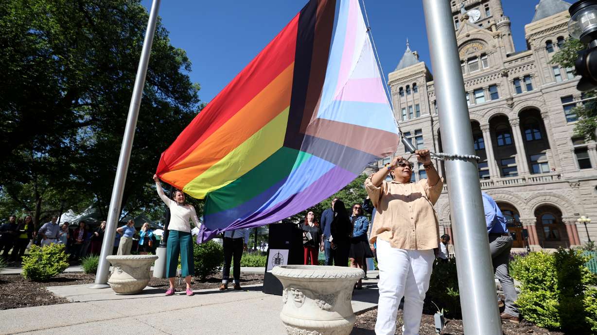 Tanya Hawkins, Utah Pride Center co-CEO, helps raise the Progress Pride flag during a ceremony to kick off Pride Month outside of the Salt Lake City-County Building in Salt Lake City on Wednesday.