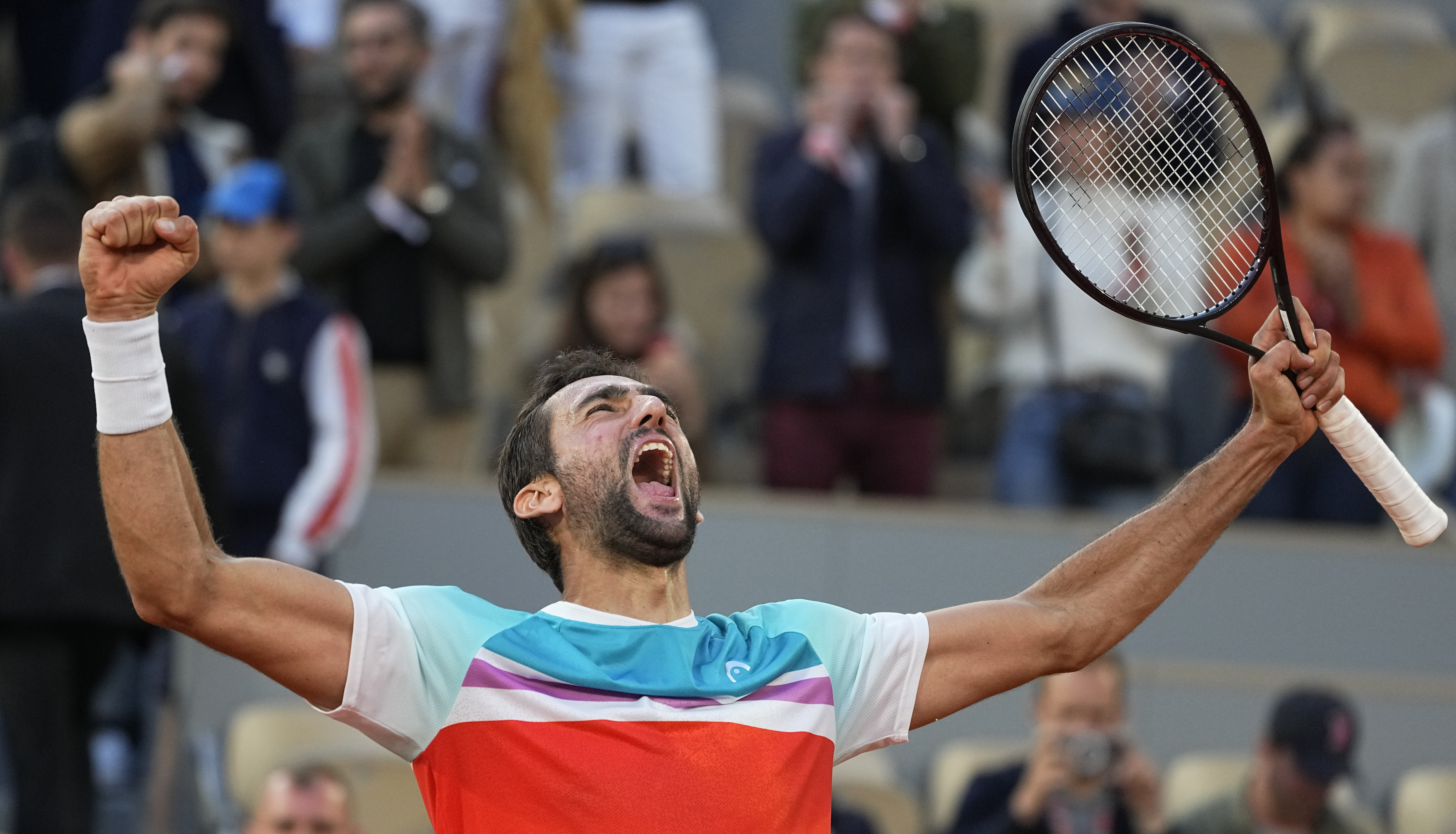 Croatia's Marin Cilic celebrates winning his quarterfinal match against Russia's Andrey Rublev in five sets, 5-7, 6-3, 6-4, 3-6, 7-6 (10-2), at the French Open tennis tournament in Roland Garros stadium in Paris, France, Wednesday, June 1, 2022. 