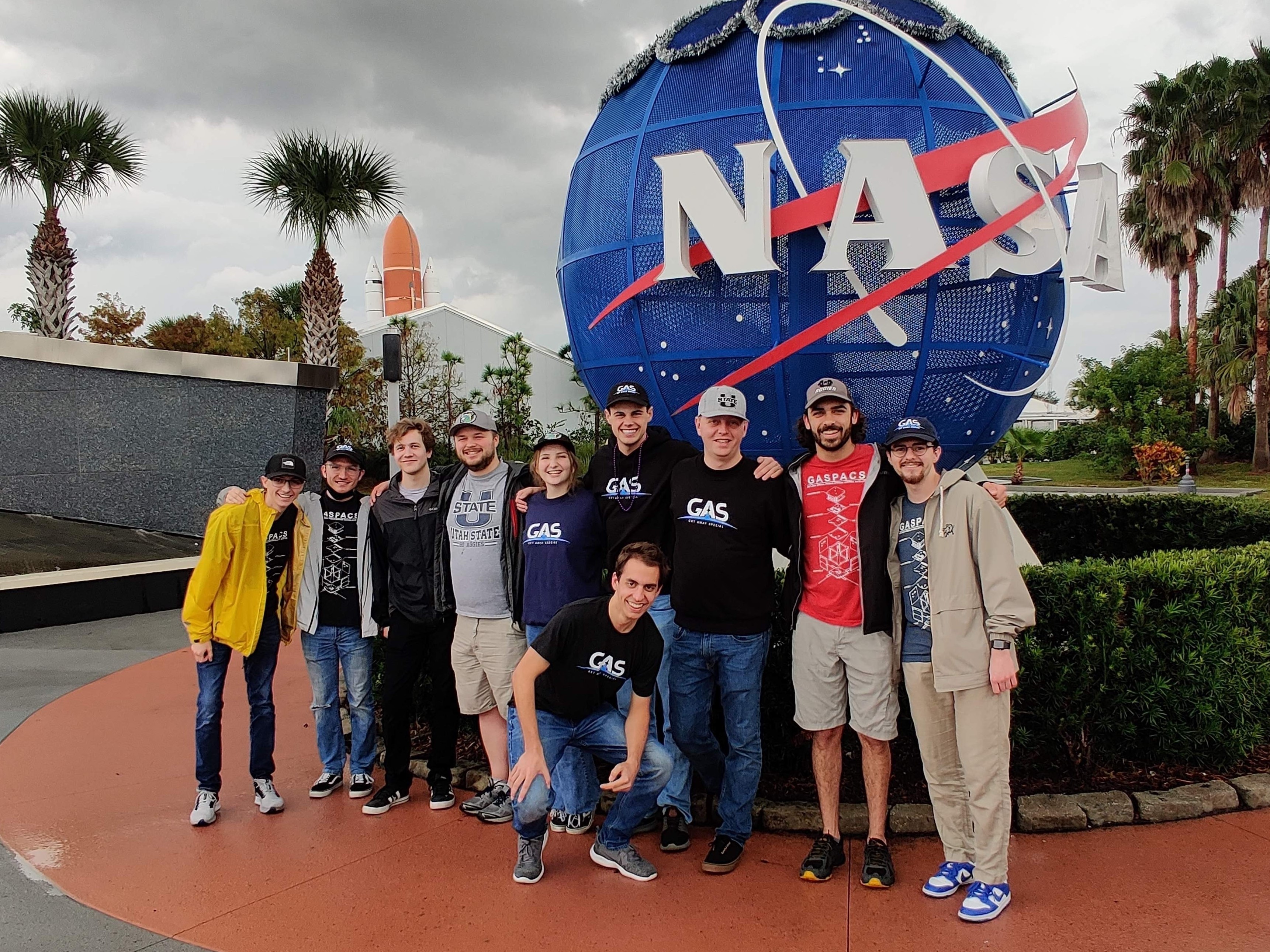 The Get Away Special team poses for a picture at NASA's Kennedy Space Center prior to watching their CubeSat, GASPACS, launch into space. The small satellite built entirely by a team of undergraduate students at Utah State University recently completed its 117-day mission in space and proved that with determination, space exploration can be accomplished by anyone.