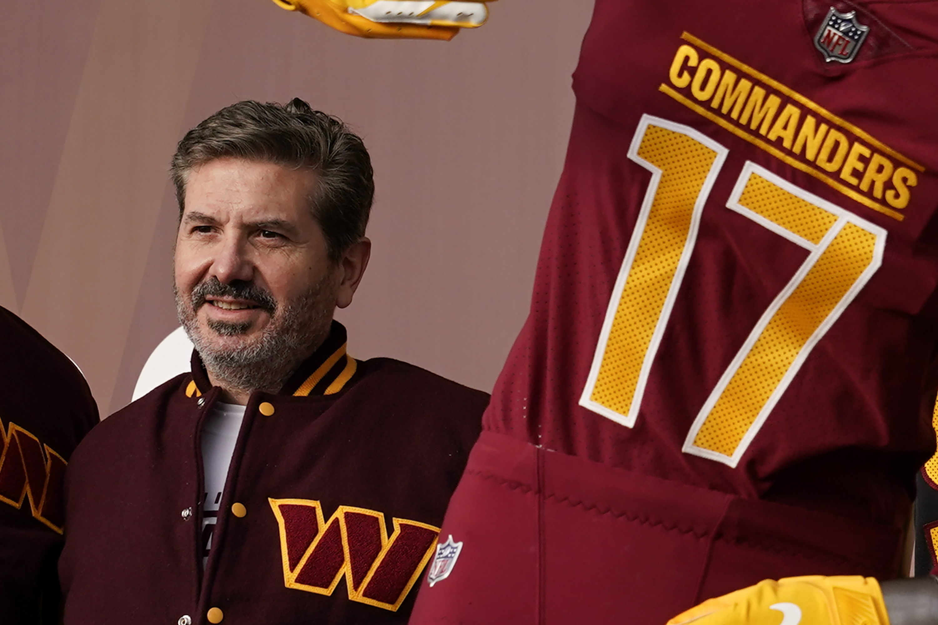 FILE - Dan Snyder, co-owner and co-CEO of the Washington Commanders, poses for photos during an event to unveil the NFL football team's new identity, Wednesday, Feb. 2, 2022, in Landover, Md. A person with knowledge of the situation tells The Associated Press the Washington Commanders have bought land in Virginia for what could be a potential site of the NFL team’s next stadium. The 200 acres of land purchased for approximately $100 million is in Woodbridge roughly 25 miles outside the District of Columbia. The Commanders’ lease at FedEx Field in Landover, Maryland, expires in 2027. 