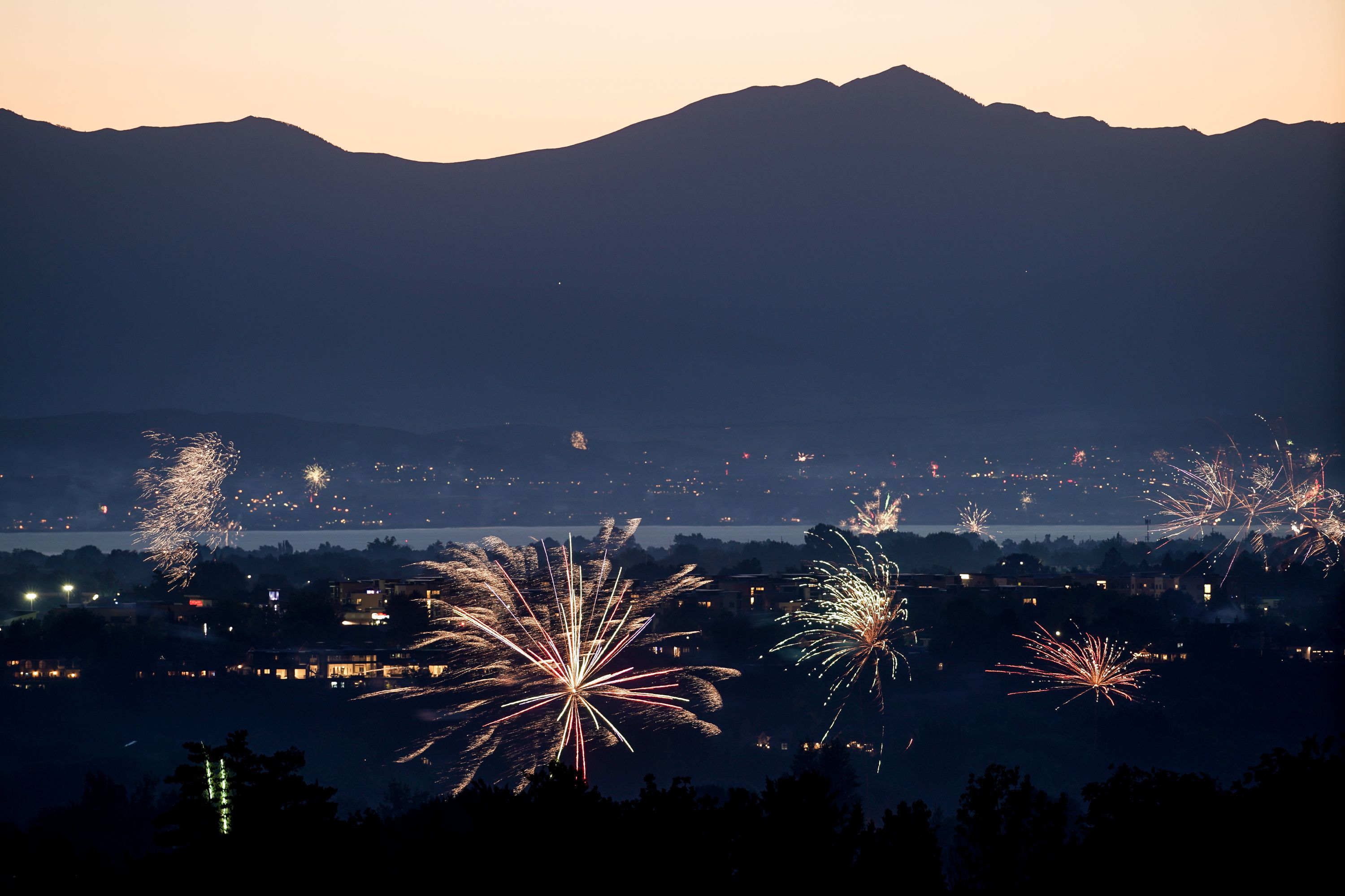 Amateur fireworks are seen from Rock Canyon Park in Provo on July 4, 2020. More than a third of Utah residents feel only government-sponsored events for specific celebrations should be allowed as the backdrop for setting off fireworks, while a quarter of the state's population say they should be banned altogether in this time of extreme drought.