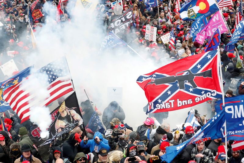Tear gas is released into a crowd of protesters at the U.S. Capitol Building in Washington, U.S, Jan. 6, 2021. The congressional inquiry into the attack on the U.S. Capitol by then-President Donald Trump's supporters enters a new phase next week, kicking off a series of public hearings with a prime-time presentation aimed at focusing attention on that day's violence.