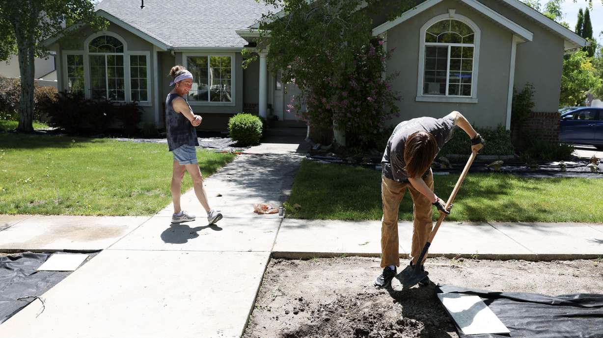 Liam Marx shovels soil over a sprinkler pipe he repaired in his yard in Layton on Thursday. Millions of residents of southern California are now limited to one day a week of outdoor irrigation, just like a huge chunk of northern Utah.