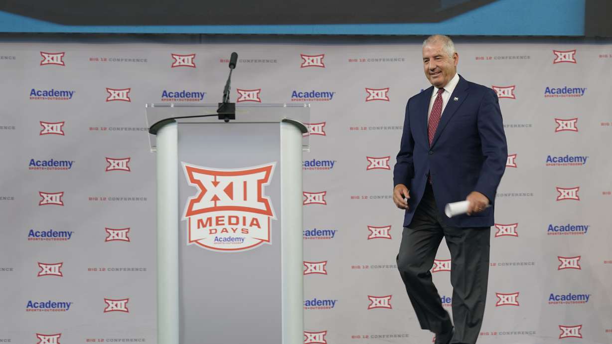 FILE - Big 12 Commissioner Bob Bowlsby walks to the podium to speak during the Big 12 football media days July 14, 2021, in Arlington, Texas. The conference is holding its spring meetings. Bowlsby, who announced his retirement earlier this year with plans to stay on until his replacement is in place, figures he is down to 30-90 days on the job.