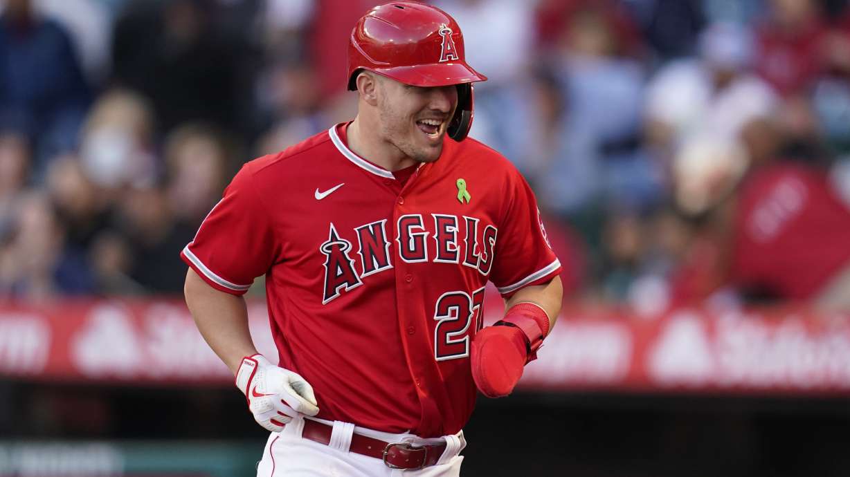 Los Angeles Angels' Mike Trout (27) runs to the dugout after scoring off of a single hit by Jared Walsh during the first inning of a baseball game against the Tampa Bay Rays in Anaheim, Calif., Tuesday, May 10, 2022.