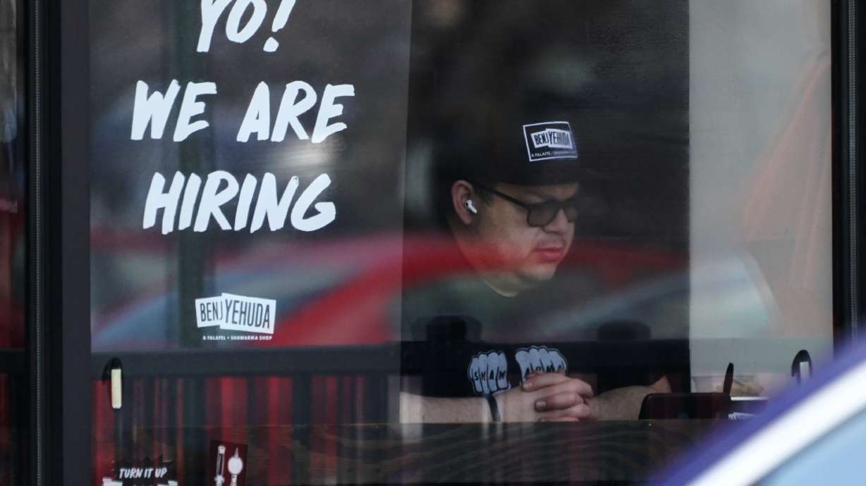 A hiring sign is displayed at a restaurant in Schaumburg, Ill., April 1. U.S. employers added 390,000 jobs in May, the U.S. Department of Labor announced Friday.