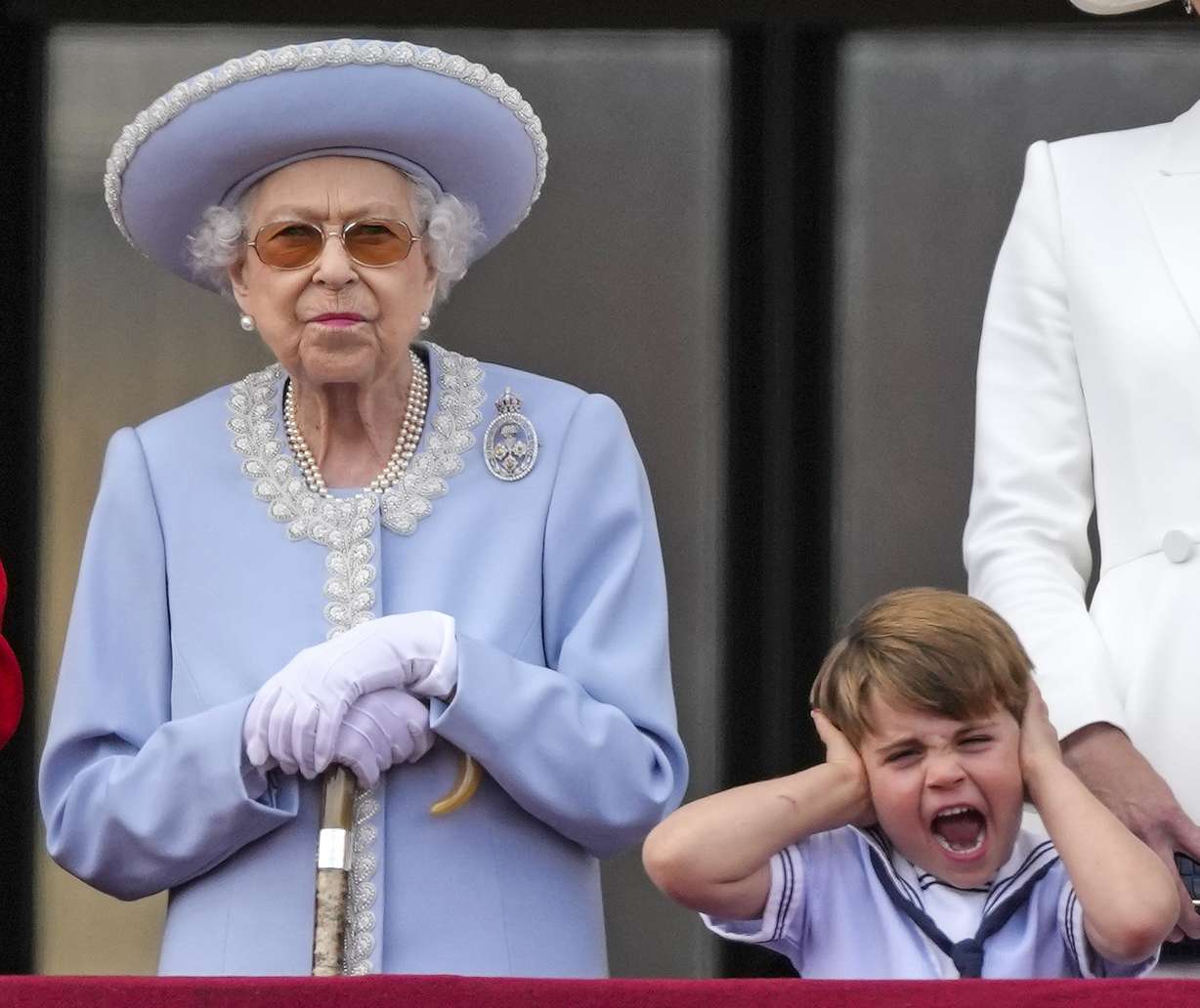 Queen Elizabeth II and Prince Louis stand on the balcony of Buckingham Palace, London, Thursday on the first of four days of celebrations to mark the Platinum Jubilee.