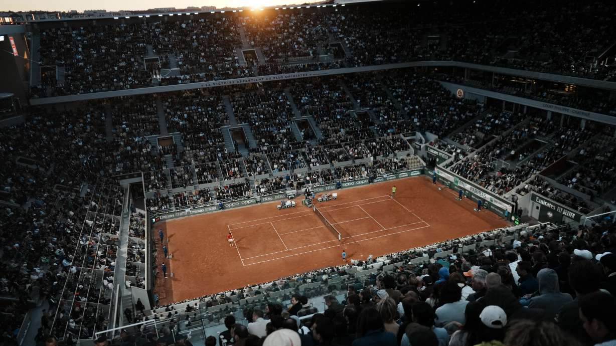 Spectators watch Serbia's Novak Djokovic playing Spain's Rafael Nadal during their quarterfinal match of the French Open tennis tournament at the Roland Garros stadium Tuesday, May 31, 2022 in Paris.