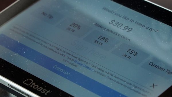 A tablet offers options for tipping.