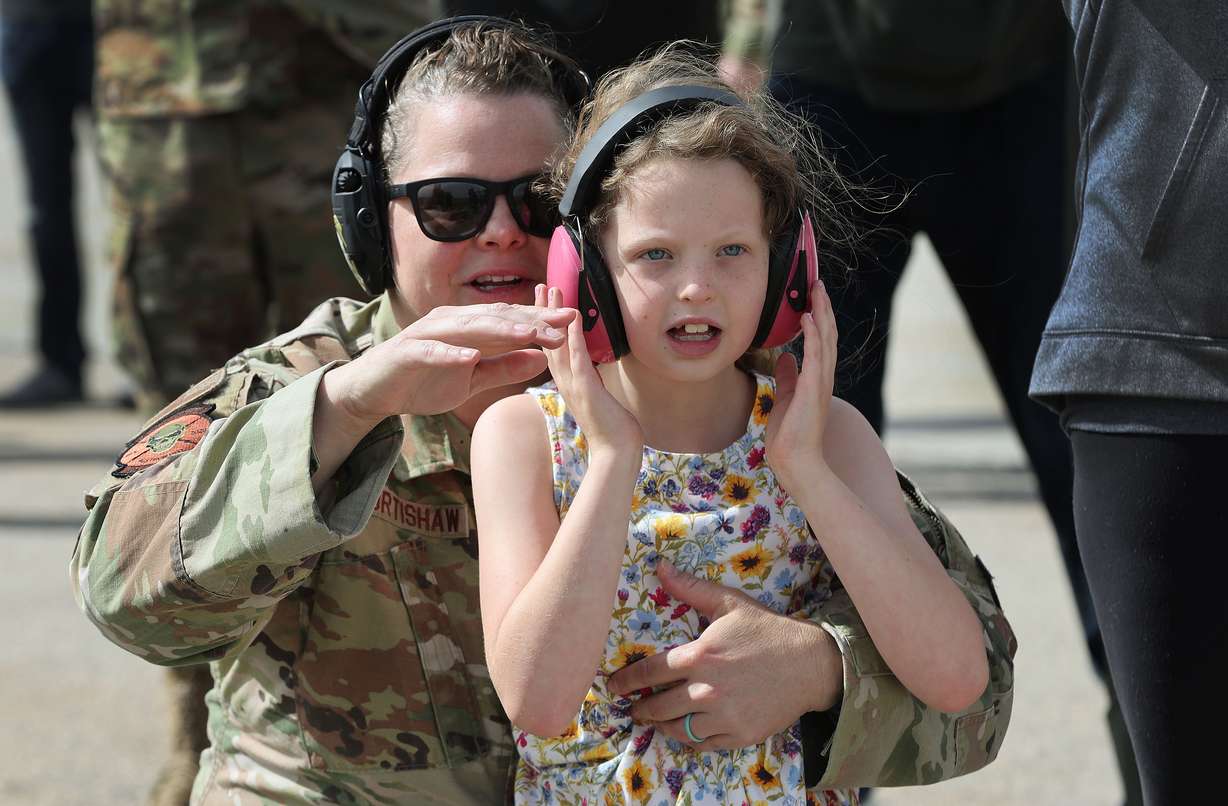 Lt. Col. Megan Murtishaw and her daughter Madline watch during an F-35A Lightning II demonstration team show at Hill Air Force Base on Friday. Maj. Kristin "BEO" Wolfe could be seen high up in the skies over the Wasatch mountains, performing aerial maneuvers during an F-35A Lightning II Demonstration Team practice show in preparation for the upcoming Warriors Over the Wasatch Air and Space Show.