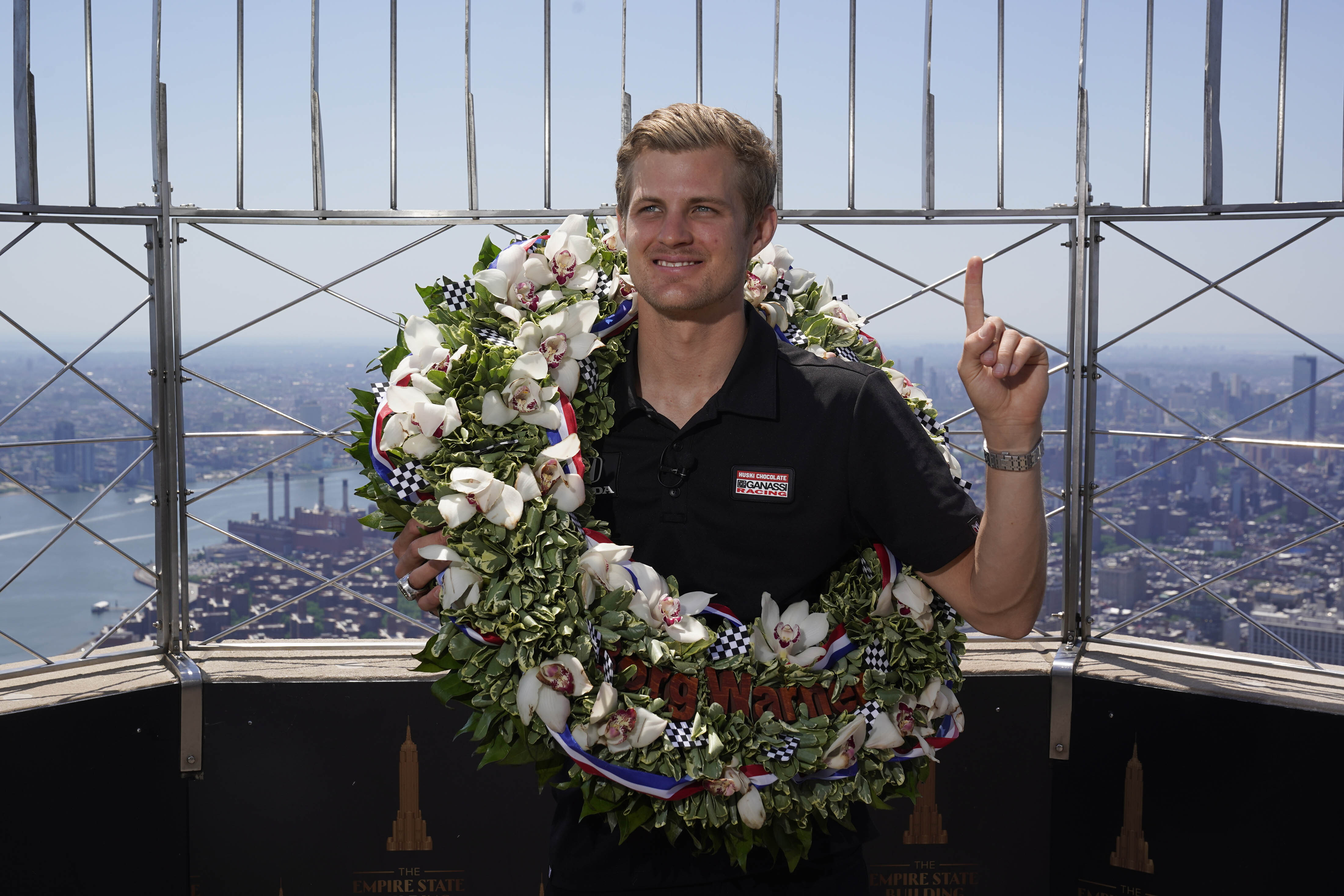 Marcus Ericsson, of Sweden, poses for pictures on the observation desk of the Empire State Building in New York, Tuesday, May 31, 2022. Ericsson won the 106th running of the Indianapolis 500 auto race on Sunday. 