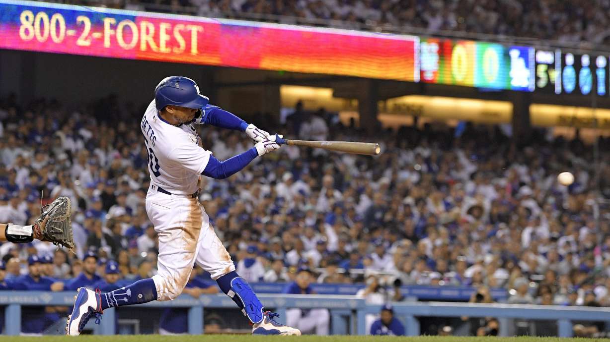 Los Angeles Dodgers' Mookie Betts hits an RBI single during the fifth inning of a baseball game against the New York Mets on Thursday, June 2, 2022, in Los Angeles.