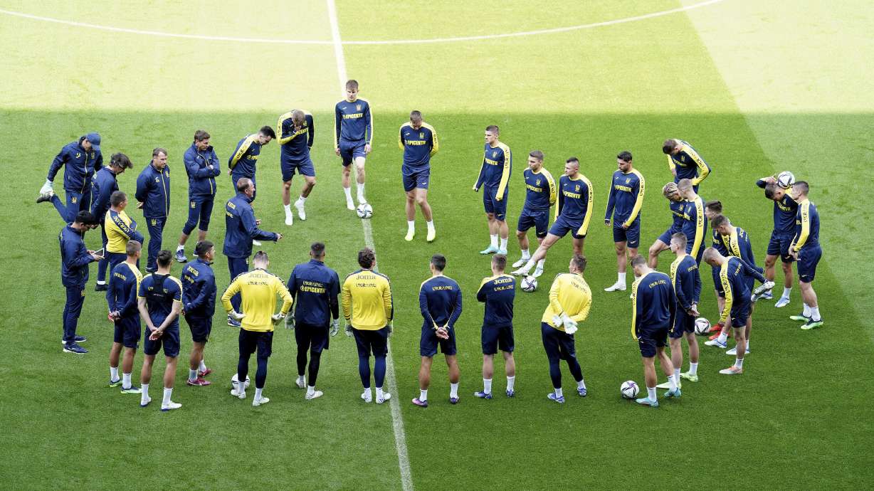Ukraine players form a circle during a training session at the Cardiff City Stadium, Cardiff, Wales Saturday June 4, 2022, the day before the team play Wales in a World Cup play-off soccer match.