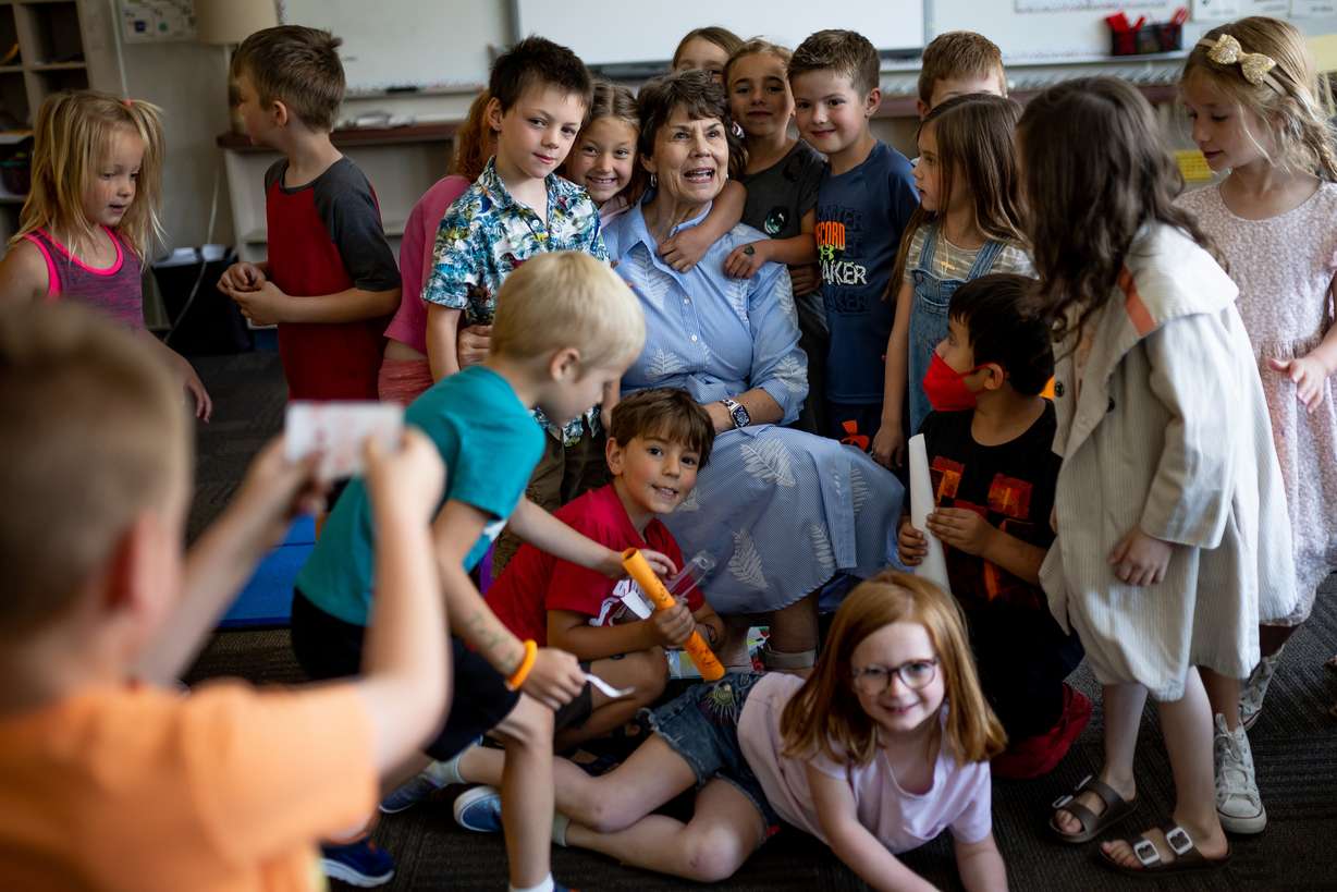 Kindergarten students crowd around teacher Louise Bitner for a portrait on the last day of school at Dilworth Elementary in Salt Lake City on Friday. Bitner, 73, is retiring after 51 years of teaching.