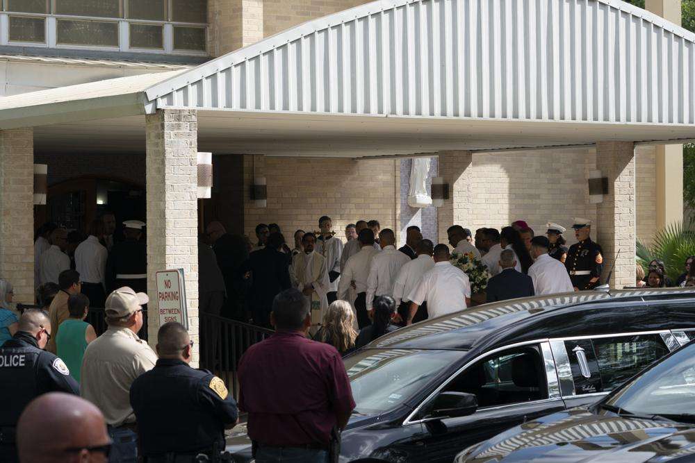 Pallbearers carry the caskets of Irma Garcia, a school teacher who was killed in last week's elementary school shooting, and her husband, Joe, who died a couple of days later, into Sacred Heart Catholic Church for a funeral service in Uvalde, Texas, Wednesday.