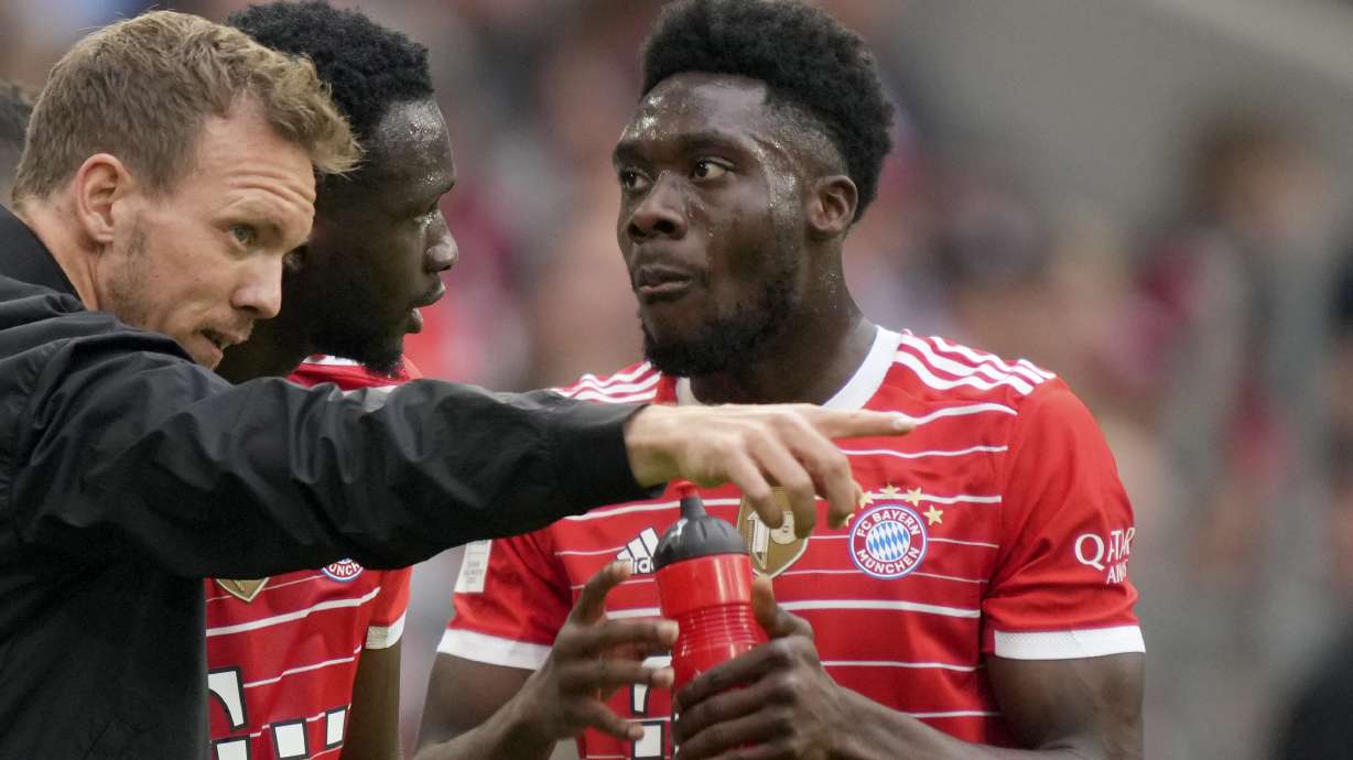 Bayern's head coach Julian Nagelsmann, left, gives instructions to Tanguy Nianzou, center, and Alphonso Davies during the German Bundesliga soccer match between Bayern Munich and Stuttgart, at the Allianz Arena, in Munich, Germany, Sunday, May 8, 2022.