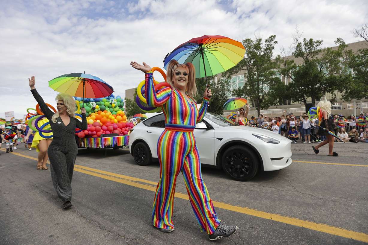 Adobe employees wave to paradegoers during the Utah Pride Parade along 200 South in Salt Lake City on Sunday.