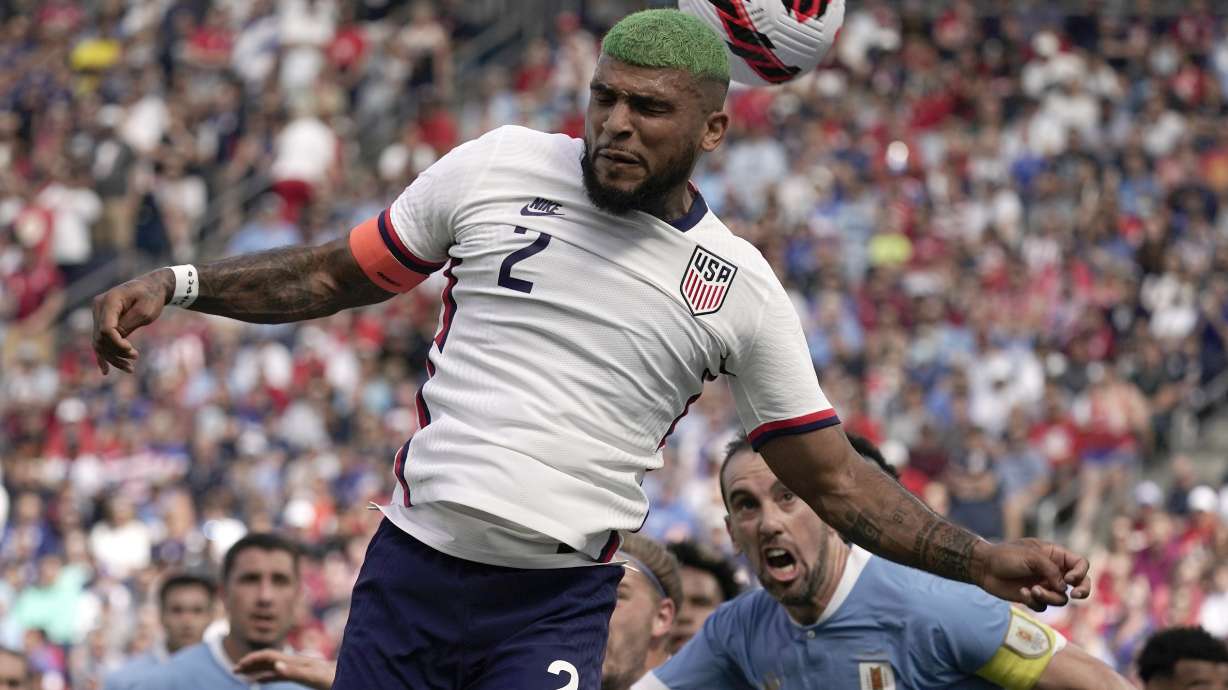 USA defender DeAndre Yedlin (2) blocks a shot attempt during the first half of an international friendly soccer match against Uruguay Sunday, June 5, 2022, in Kansas City, Kan.