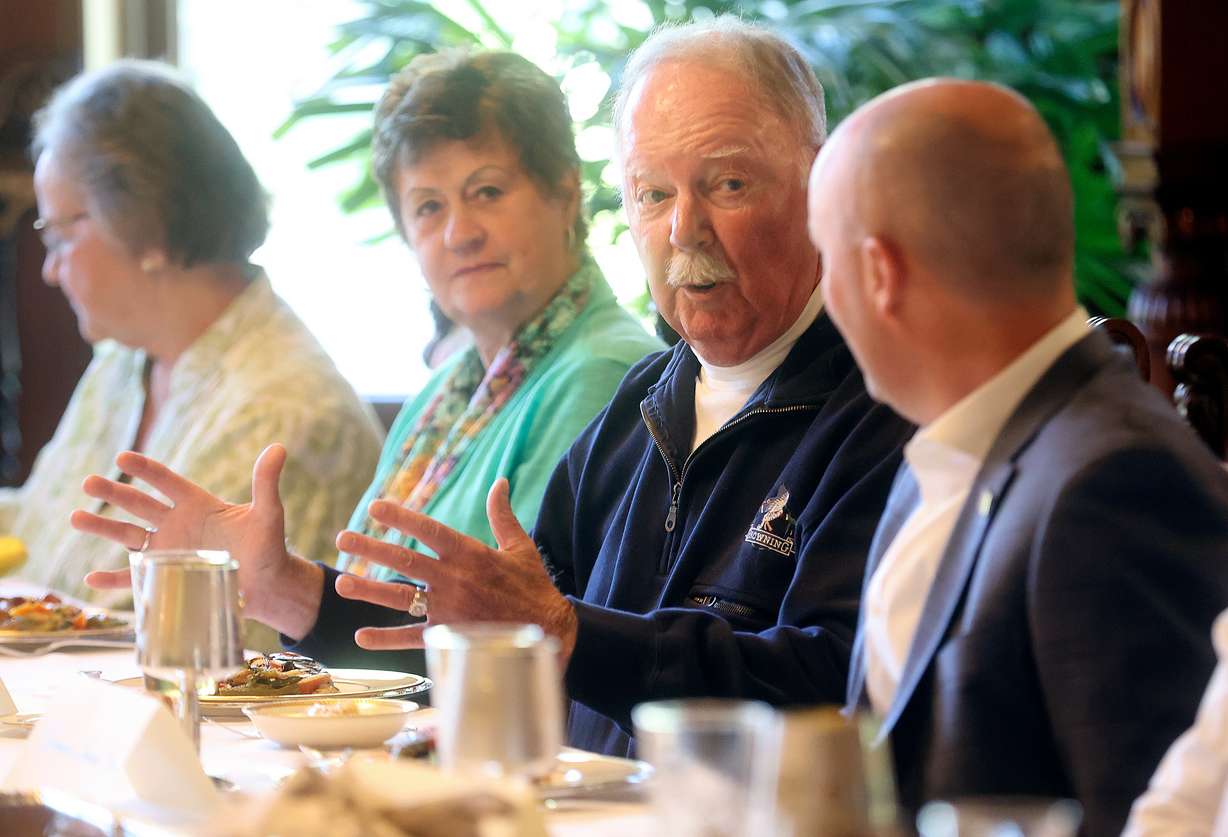 Bert (B.J.) Florek, third from left, tells Gov. Spencer Cox, right, a fishing story during a dinner for the longest lifetime state fishing license holders at the Governor’s Mansion in Salt Lake City on Wednesday, May 25.