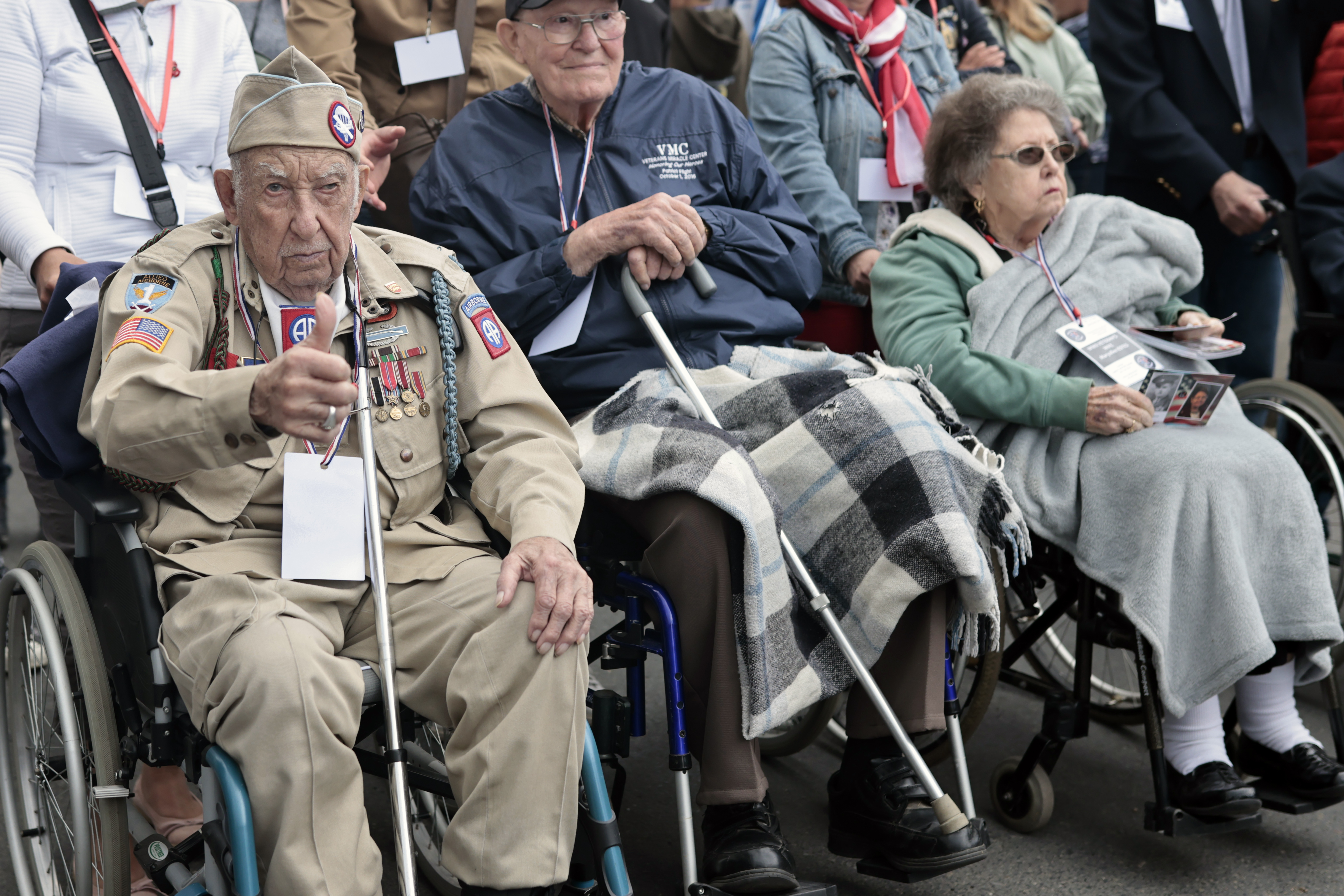 US WWII veteran Ray Wallace, of the 507th PIR 82rd Airborne, looks on as World War II history enthusiasts parade in WWII vehicles to commemorate the 78th anniversary of D-Day that led to the liberation of France and Europe from the German occupation, in Sainte-Mere-L'Eglise, Normandy, Sunday.