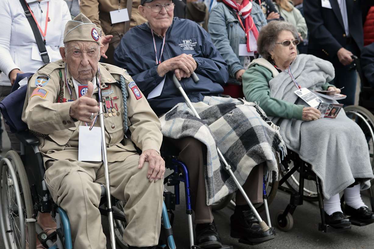 US WWII veteran Ray Wallace, of the 507th PIR 82rd Airborne, looks on as World War II history enthusiasts parade in WWII vehicles to commemorate the 78th anniversary of D-Day that led to the liberation of France and Europe from the German occupation, in Sainte-Mere-L'Eglise, Normandy, Sunday.