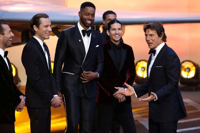 U.S. actor Tom Cruise reacts next to fellow cast and crew members during the premiere of 'Top Gun: Maverick' in London, May 19. The family of the author whose article inspired the 1986 movie "Top Gun" on Monday sued Paramount Pictures for copyright infringement over this year's blockbuster sequel "Top Gun: Maverick."