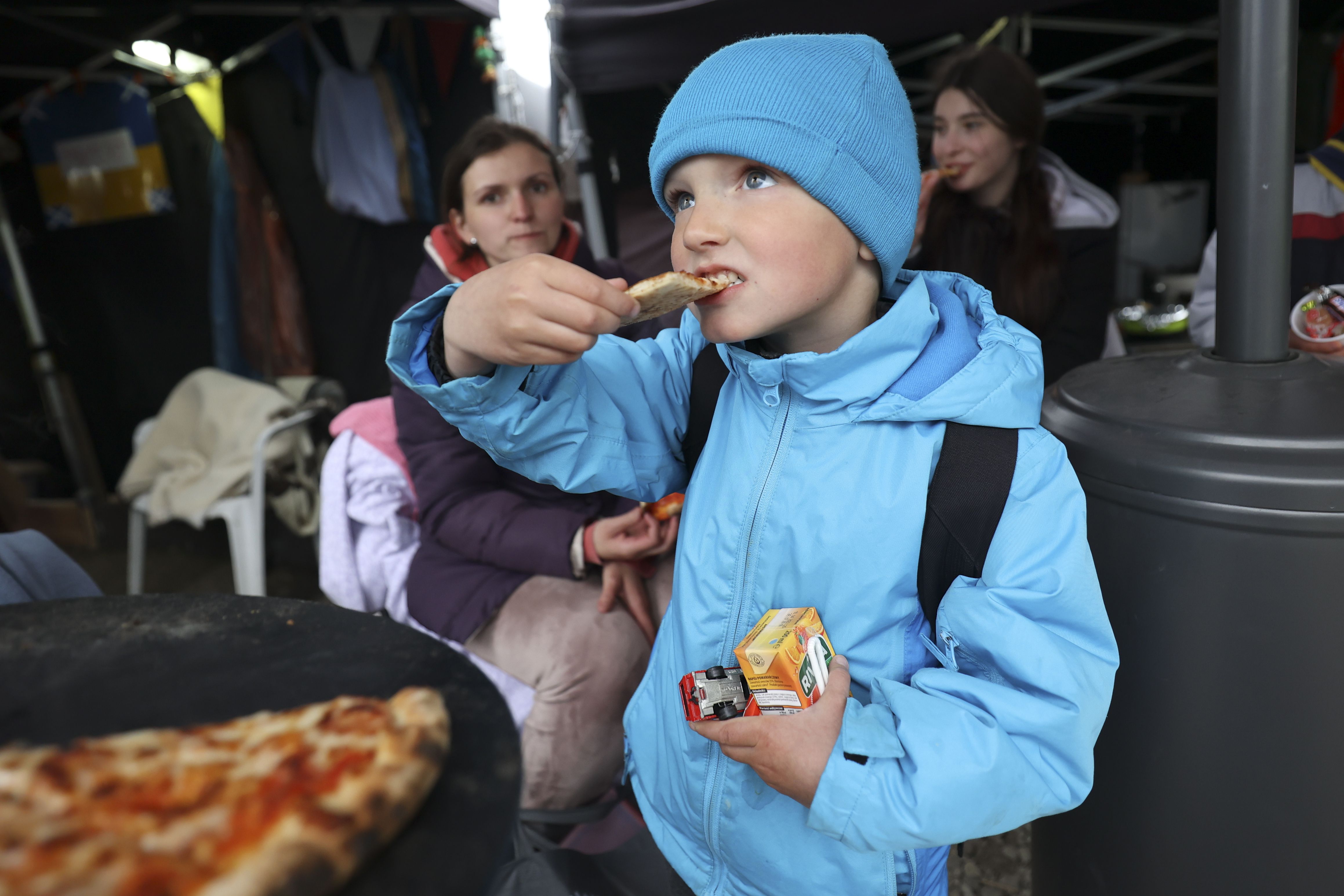 Artyom Chepel, 4, eats pizza in the Siobhan’s Trust tent after crossing the Ukrainian-Polish border in Medyka, Poland, on April 21. Over 48,000 Americans have now signed up to help Ukrainians displaced by the Russian invasion, making it one of the largest community-based sponsorship programs for refugees in U.S. history.