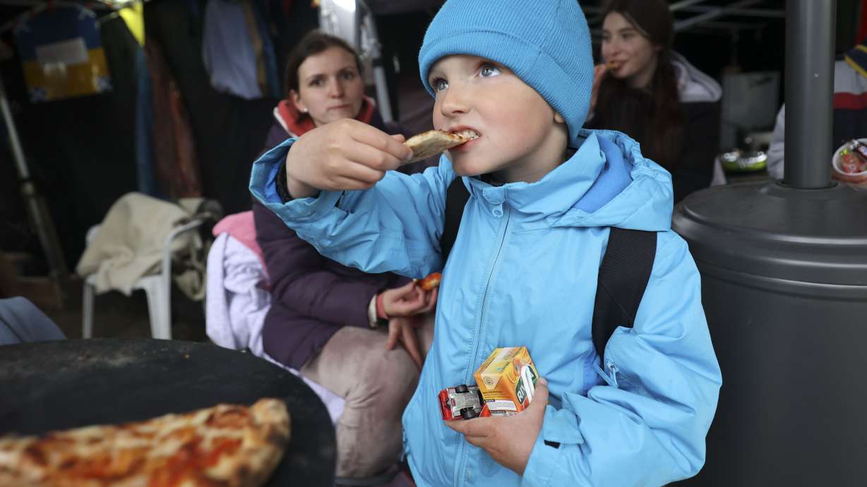 Artyom Chepel, 4, eats pizza in the Siobhan’s Trust tent after crossing the Ukrainian-Polish border in Medyka, Poland, on April 21. Over 48,000 Americans have now signed up to help Ukrainians displaced by the Russian invasion, making it one of the largest community-based sponsorship programs for refugees in U.S. history.