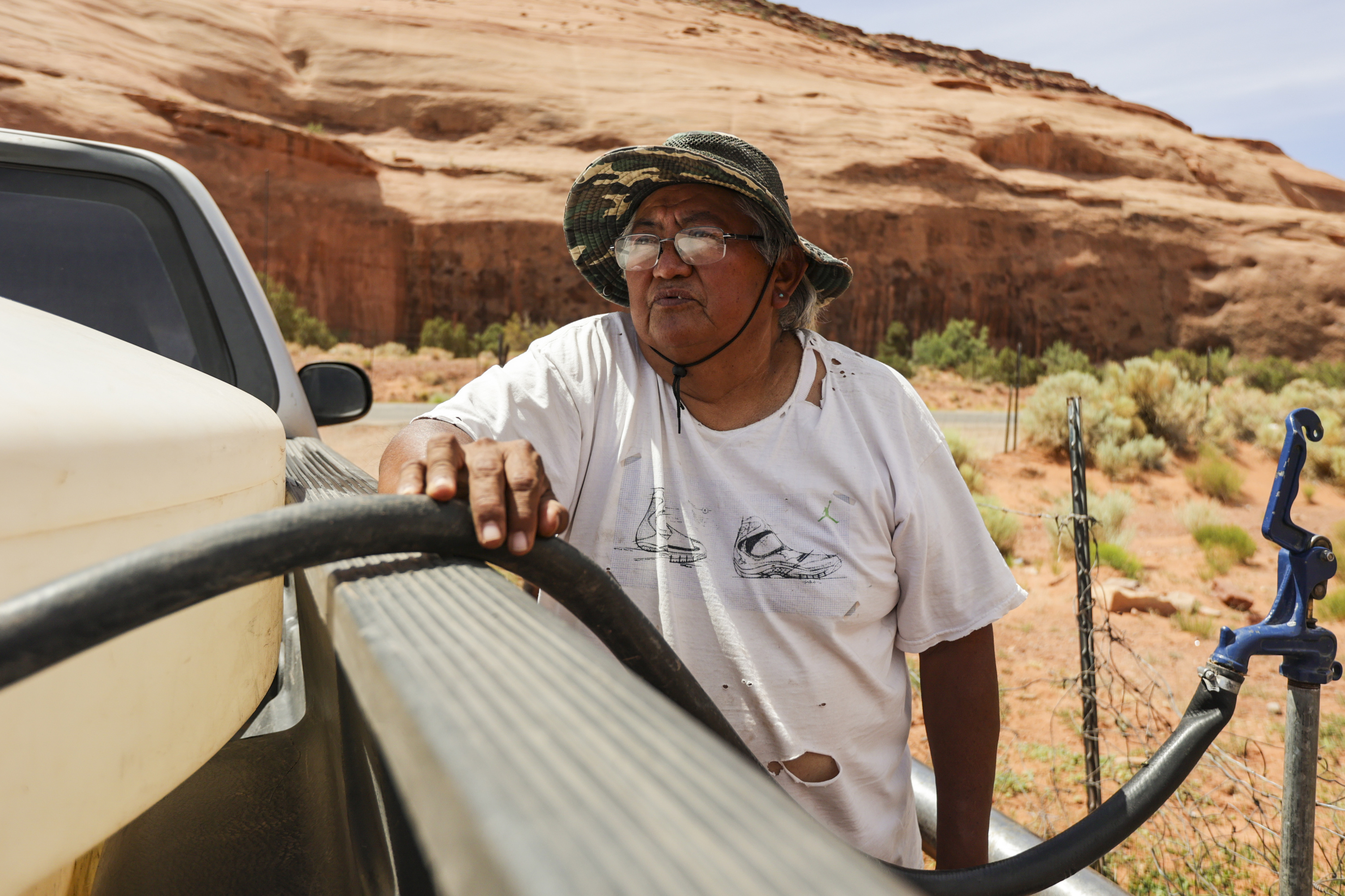 Ron Atine is pictured while waiting for a tank to fill with water at a well in Goulding, San Juan County, on May 27. U.S. Secretary of the Interior Deb Haaland and Utah Gov. Spencer J. Cox joined Jonathan Nez, the president of the Navajo Nation, and Doreen McPaul, the Navajo Nation attorney general, to sign a federal reserved water rights settlement agreement.