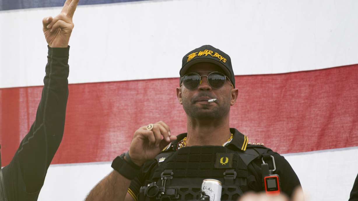 Proud Boys leader Enrique Tarrio wears a hat that says The War Boys and smokes a cigarette at a rally in Delta Park on Sept. 26, 2020, in Portland, Ore. Tarrio, the former top leader of the far-right Proud Boys extremist group, and other members were indicted Monday, on seditious conspiracy charges for what federal prosecutors say was a coordinated attack on the U.S. Capitol to stop Congress from certifying President Joe Biden's 2020 electoral victory.