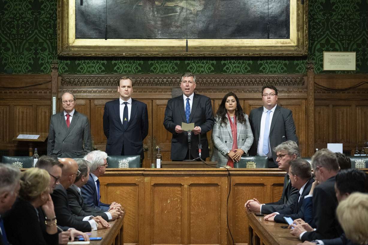 Sir Graham Brady, Chairman of the 1922 Committee of Conservative backbenchers, announces that Britain's Prime Minister Boris Johnson has survived an attempt by Tory MPs to oust him as party leader following a confidence vote in his leadership at the Houses of Parliament, in London, Monday.