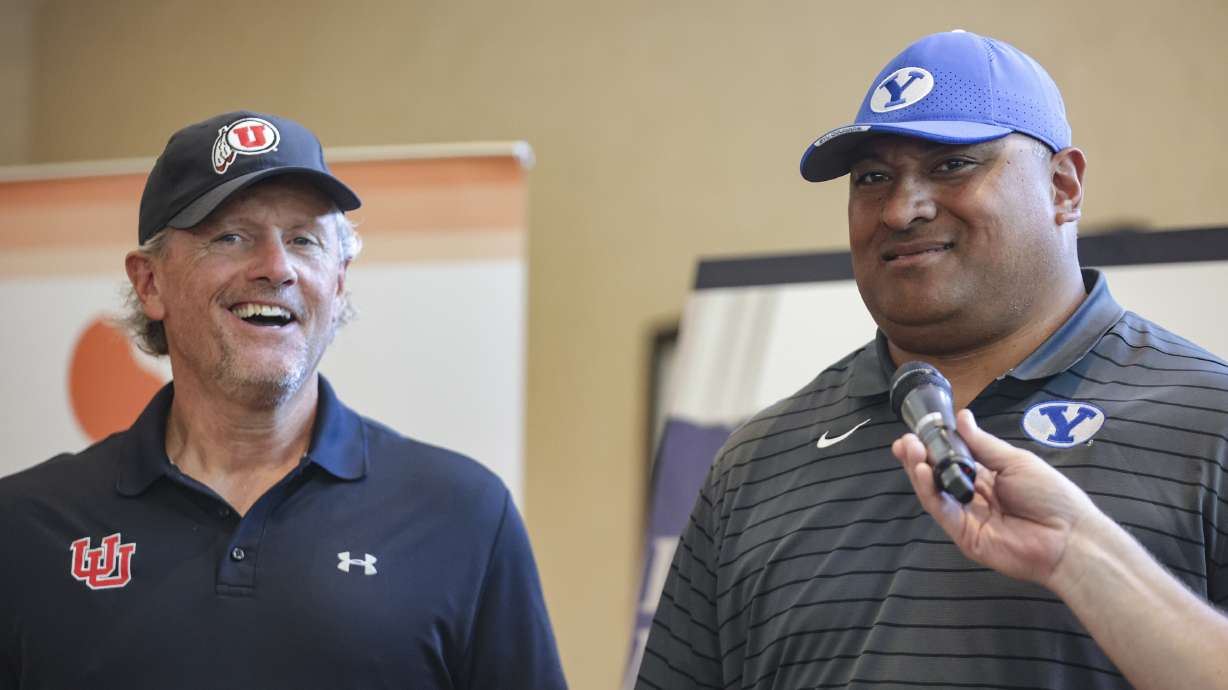 Utah Utes football head coach Kyle Whittingham and BYU Cougars head coach Kalani Sitake laugh during a ceremony for the Coaches Legacy Golf Invitational at Hidden Valley Country Club in Sandy on Monday, June 6, 2022.