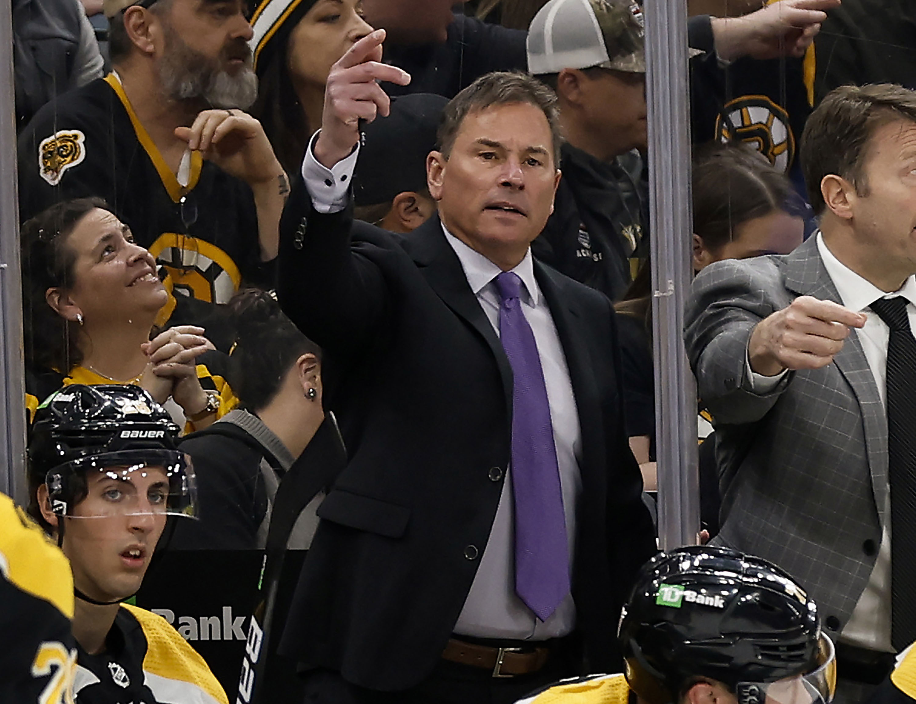 FILE -Boston Bruins head coach Bruce Cassidy, center, gestures during the third period of an NHL hockey game against the Pittsburgh Penguins, April 16, 2022, in Boston. The Bruins have fired Cassidy several weeks after losing in the first round of the playoffs. 