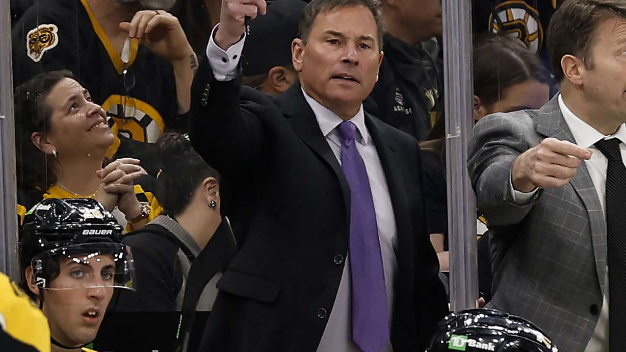 FILE -Boston Bruins head coach Bruce Cassidy, center, gestures during the third period of an NHL hockey game against the Pittsburgh Penguins, April 16, 2022, in Boston. The Bruins have fired Cassidy several weeks after losing in the first round of the playoffs.
