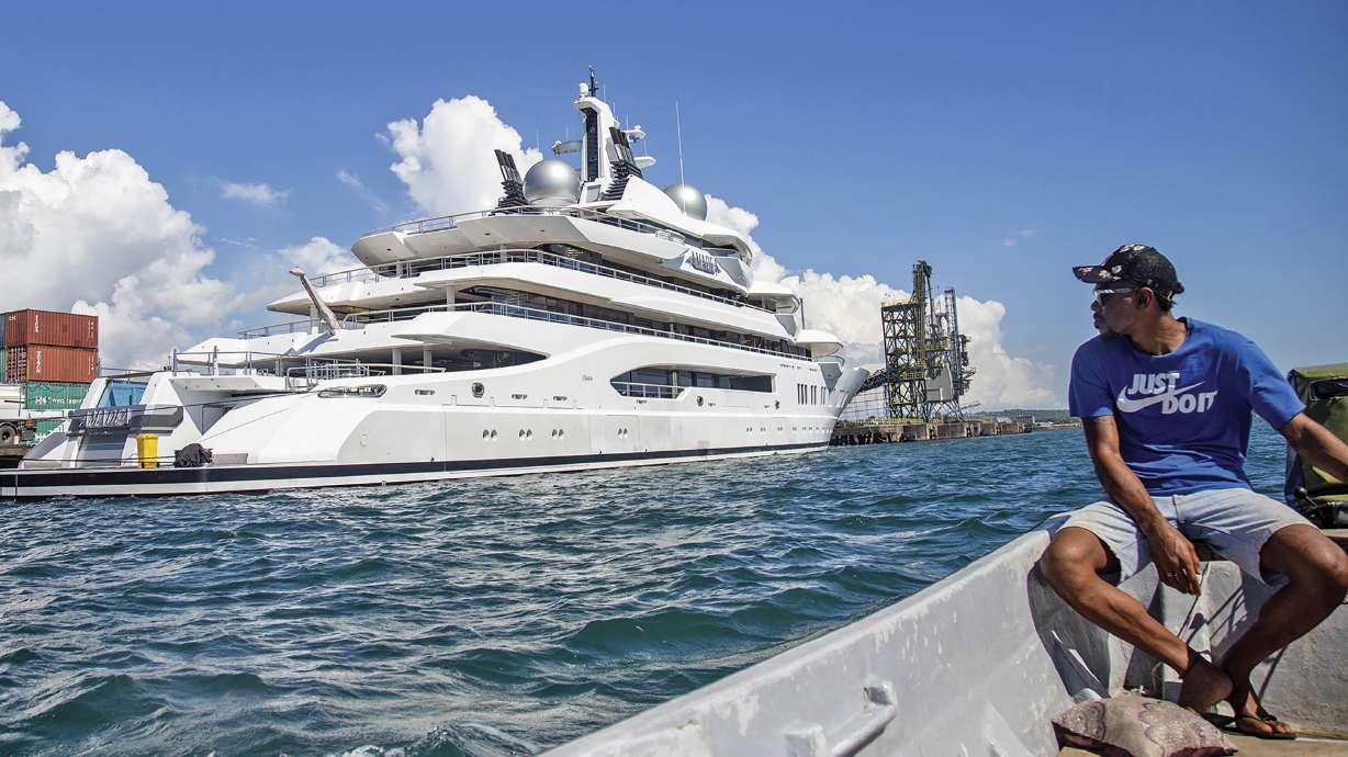Boat captain Emosi Dawai looks at the superyacht Amadea where it is docked at the Queens Wharf in Lautoka, Fiji, on April 13. The U.S. has won a legal battle to seize a Russian-owned superyacht in Fiji and wasted no time in taking command of the vessel and sailing it away from the South Pacific nation.
