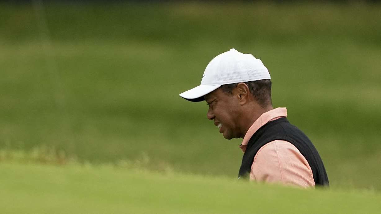 Tiger Woods grimaces on the 18th hole during the third round of the PGA Championship golf tournament at Southern Hills Country Club, Saturday, May 21, 2022, in Tulsa, Okla.
