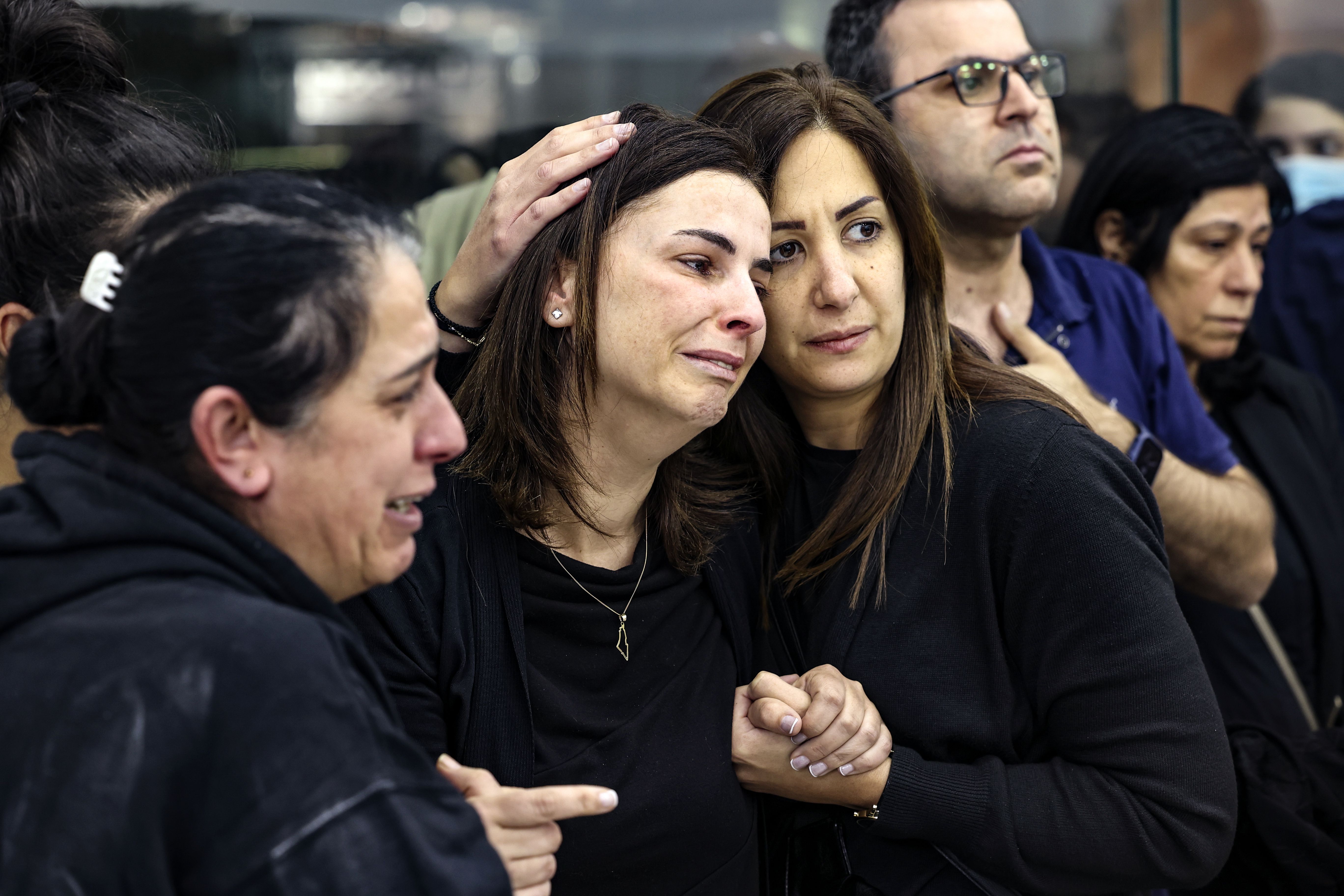 Colleagues and friends react as the Palestinian flag-draped body of veteran Al-Jazeera journalist Shireen Abu Akleh is brought to the news channel’s office in the West Bank city of Ramallah, May 11.