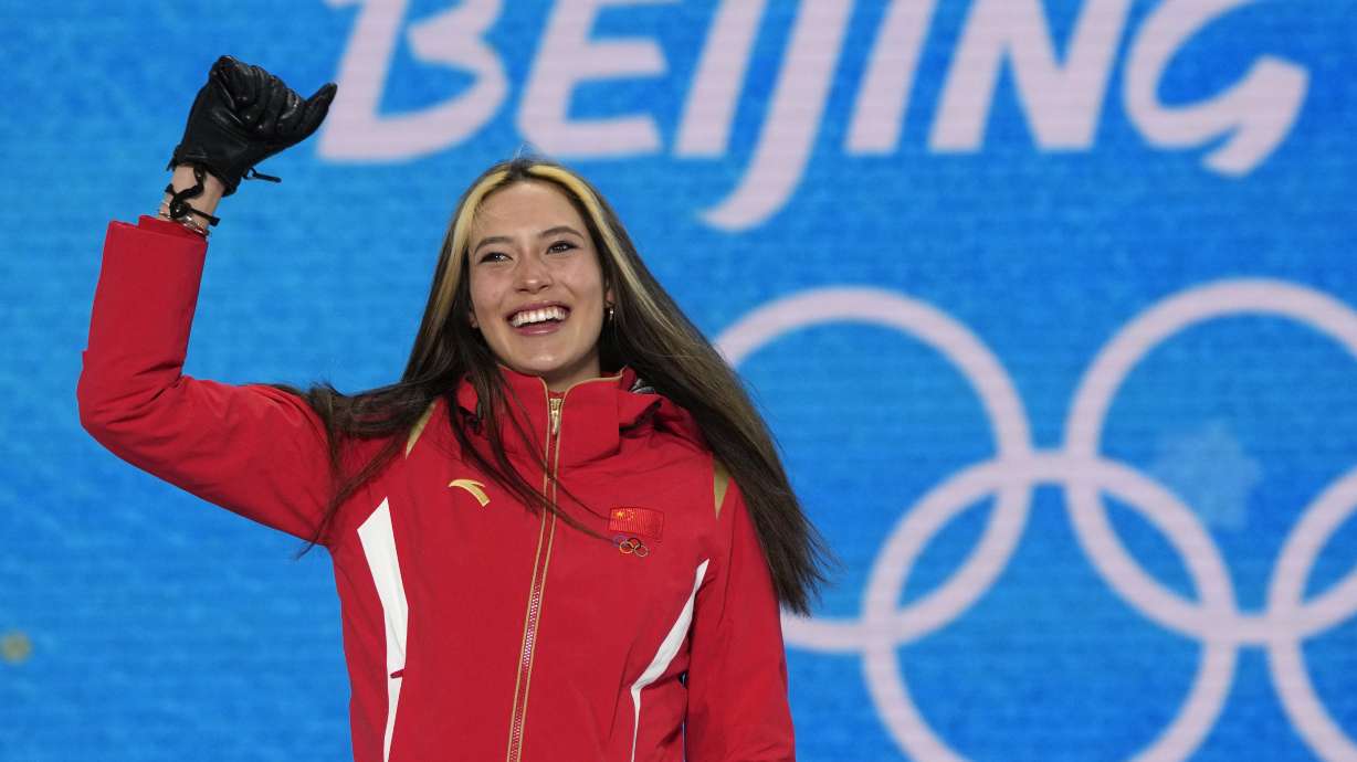 FILE - Gold medalist China's Eileen Gu celebrates during a medal ceremony for the women's freestyle skiing halfpipe competition at the 2022 Winter Olympics, Friday, Feb. 18, 2022, in Zhangjiakou, China. Gu, the California-born athlete who won two gold medals for China in freestyle skiing at the recent Beijing Olympics, has signed on to work for Salt Lake City's bid for the 2030 or 2034 Winter Olympics.