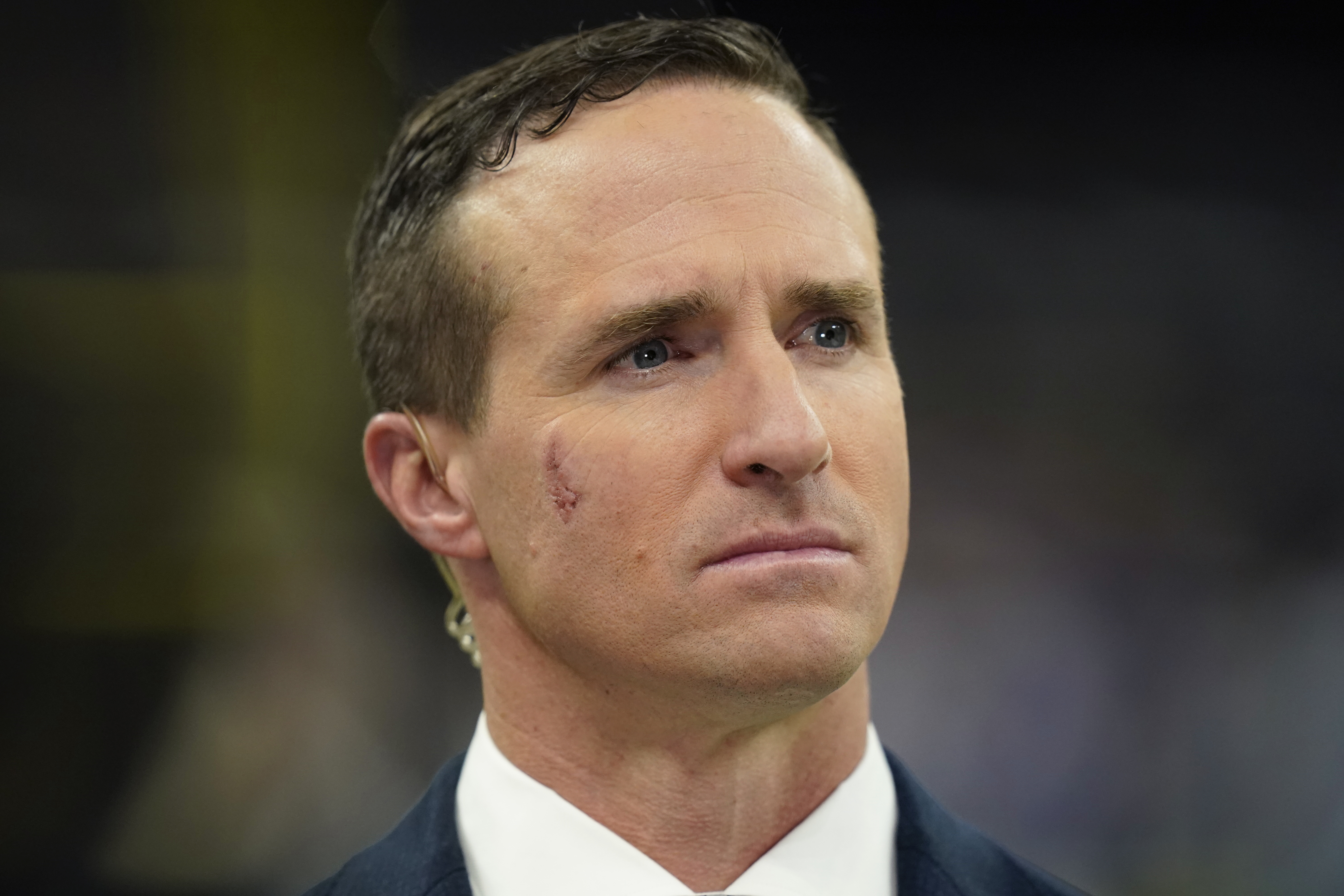 FILE - Former New Orleans Saints quarterback Drew Brees, now a TV analyst, talks on the field before an NFL football game against the Buffalo Bills in New Orleans, on Nov. 25, 2021. Brees is officially done at NBC Sports after one year. NBC Sports president Pete Bevacqua said in a phone interview with the Associated Press that Brees will not be a part of the network’s NFL and Notre Dame coverage this year.