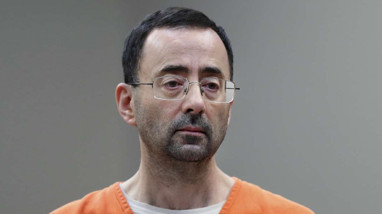 Dr. Larry Nassar, appears in court for a plea hearing on Nov. 22, 2017, in Lansing, Mich. Olympic gold medalist Simone Biles and dozens of other women who say they were sexually assaulted by Nassar are seeking more than $1 billion from the FBI for failing to stop the sports doctor.