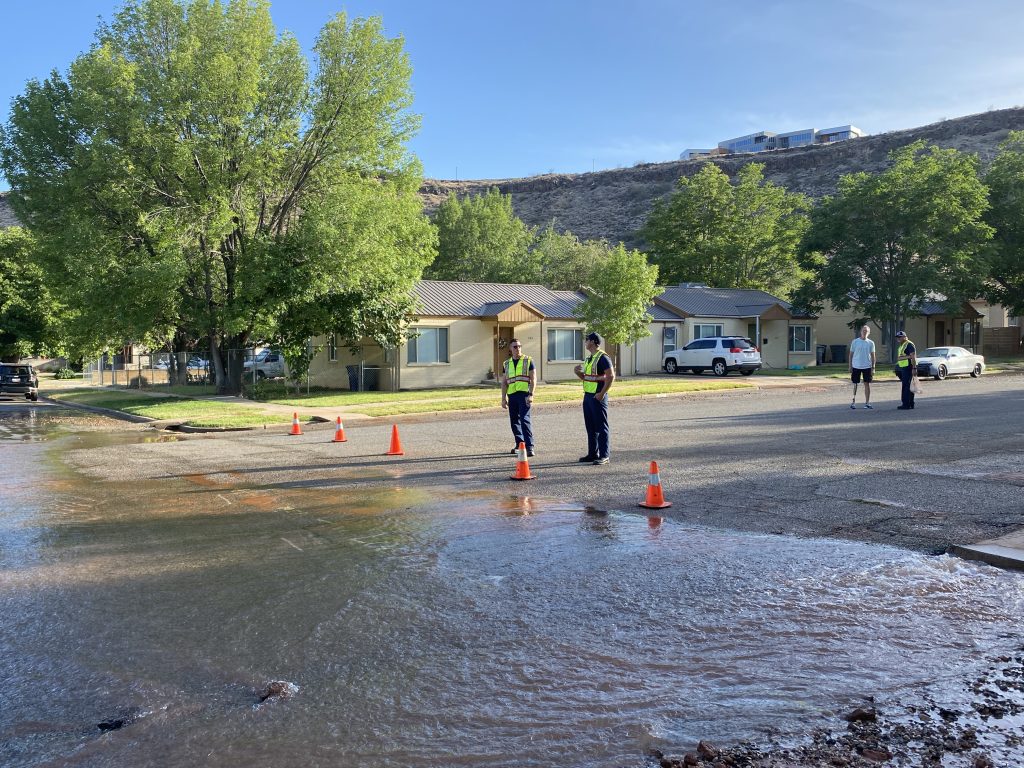 Firefighters cordon off a section of road as city workers repair a water main break in St. George, Tuesday. 