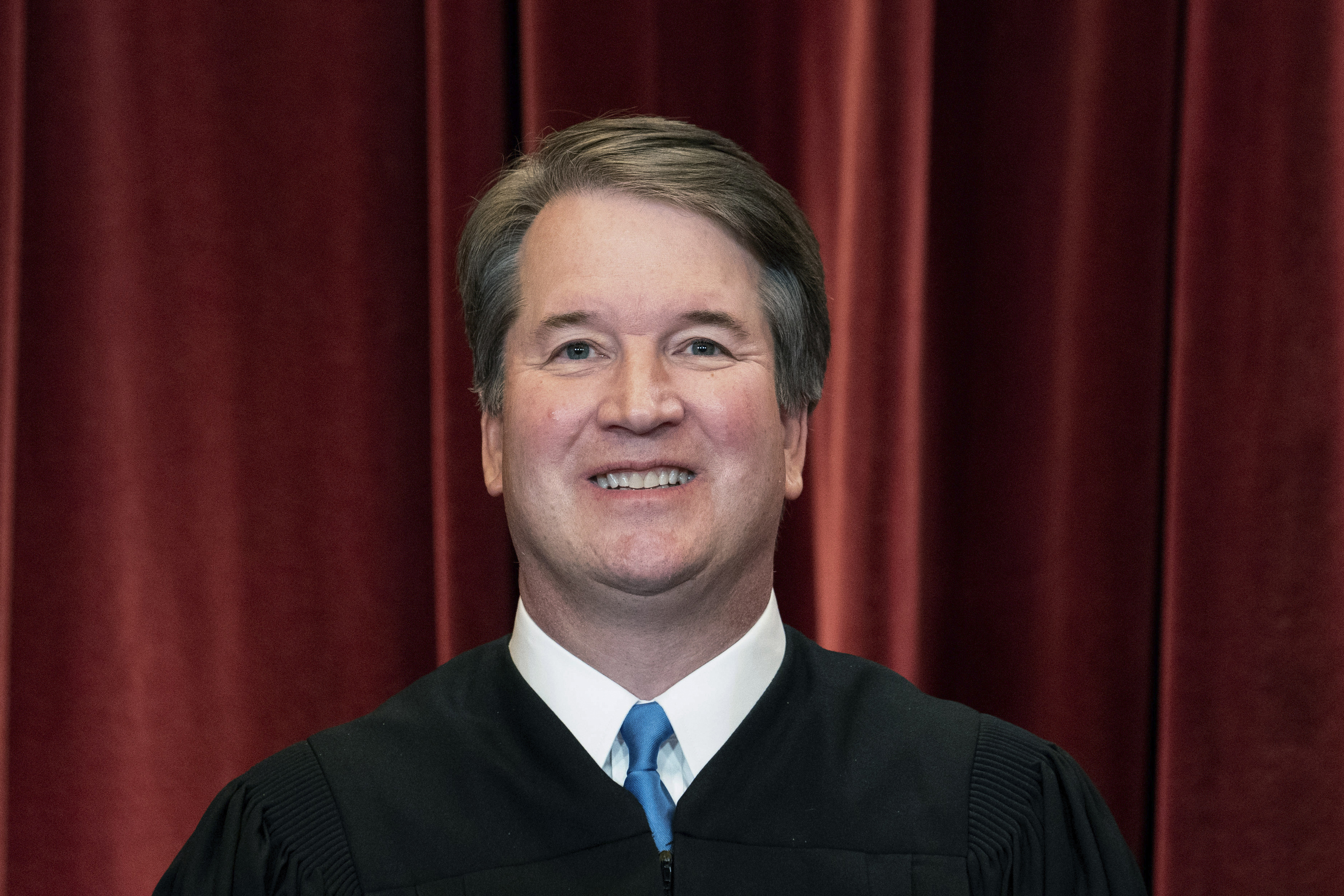 Associate Justice Brett Kavanaugh stands during a group photo at the Supreme Court in Washington, on April 23, 2021. A man carrying a gun, a knife and zip ties was arrested Wednesday near Kavanaugh's house in Maryland after threatening to kill the justice.