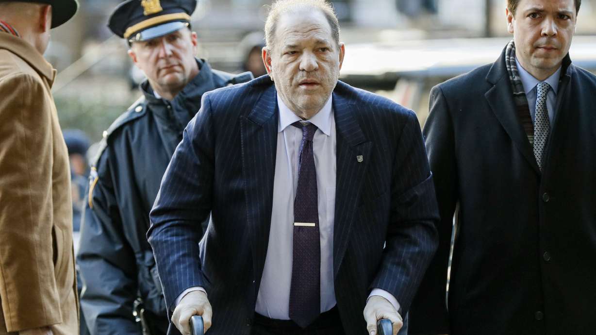 Harvey Weinstein arrives at a Manhattan courthouse as jury deliberations continue in his rape trial on Feb. 19, 2020, in New York. British prosecutors said Wednesday, they have authorized police to charge ex-film producer Harvey Weinstein with two counts of indecent assault against a woman in London in 1996.