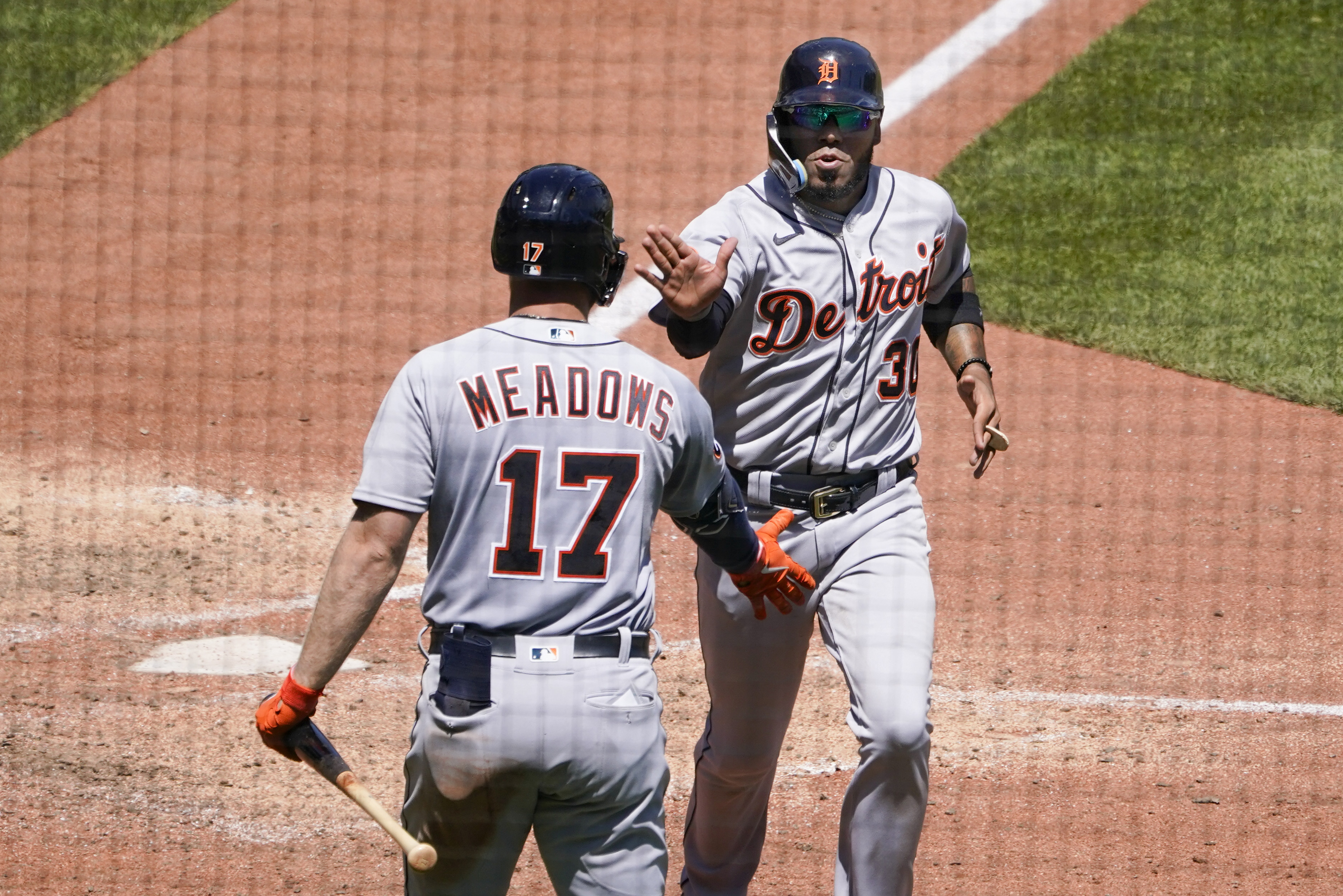 Detroit Tigers' Harold Castro, right, is greeted by Austin Meadows (17) after scoring against the Pittsburgh Pirates on a single by Miguel Cabrera during the eighth inning of a baseball game, Wednesday, June 8, 2022, in Pittsburgh. 