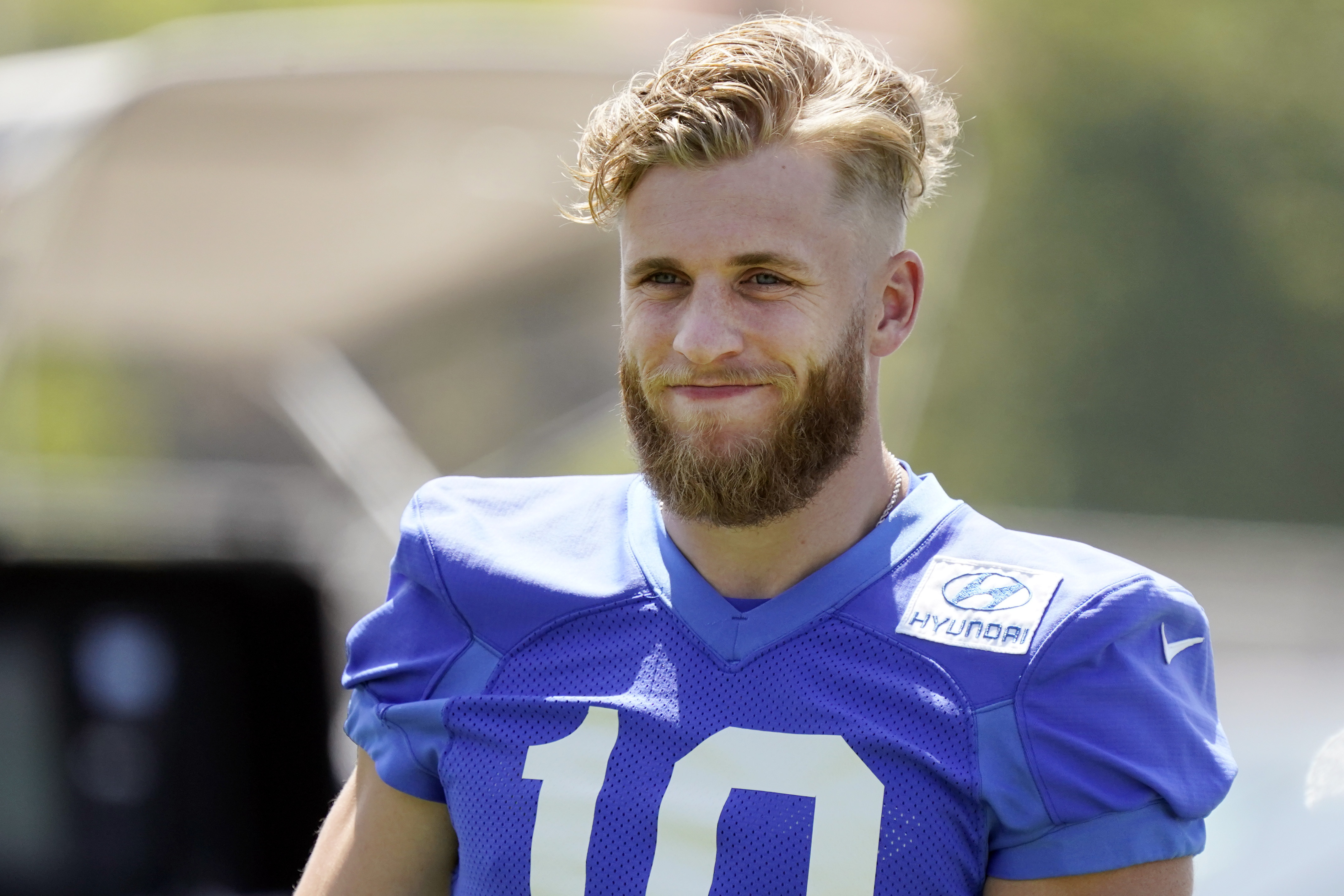 Los Angeles Rams wide receiver Cooper Kupp smiles during stretching at the NFL football team's practice facility, Thursday, May 26, 2022, in Thousand Oaks, Calif. 