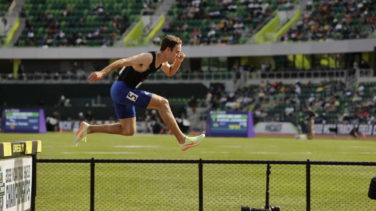 BYU's Kenneth Rooks leaps over the puddle to finish second in his heat in the 3,000-meter steeplechase semifinals Wednesday, June 8, 2022 at Hayward Field in Eugene, Oregon.